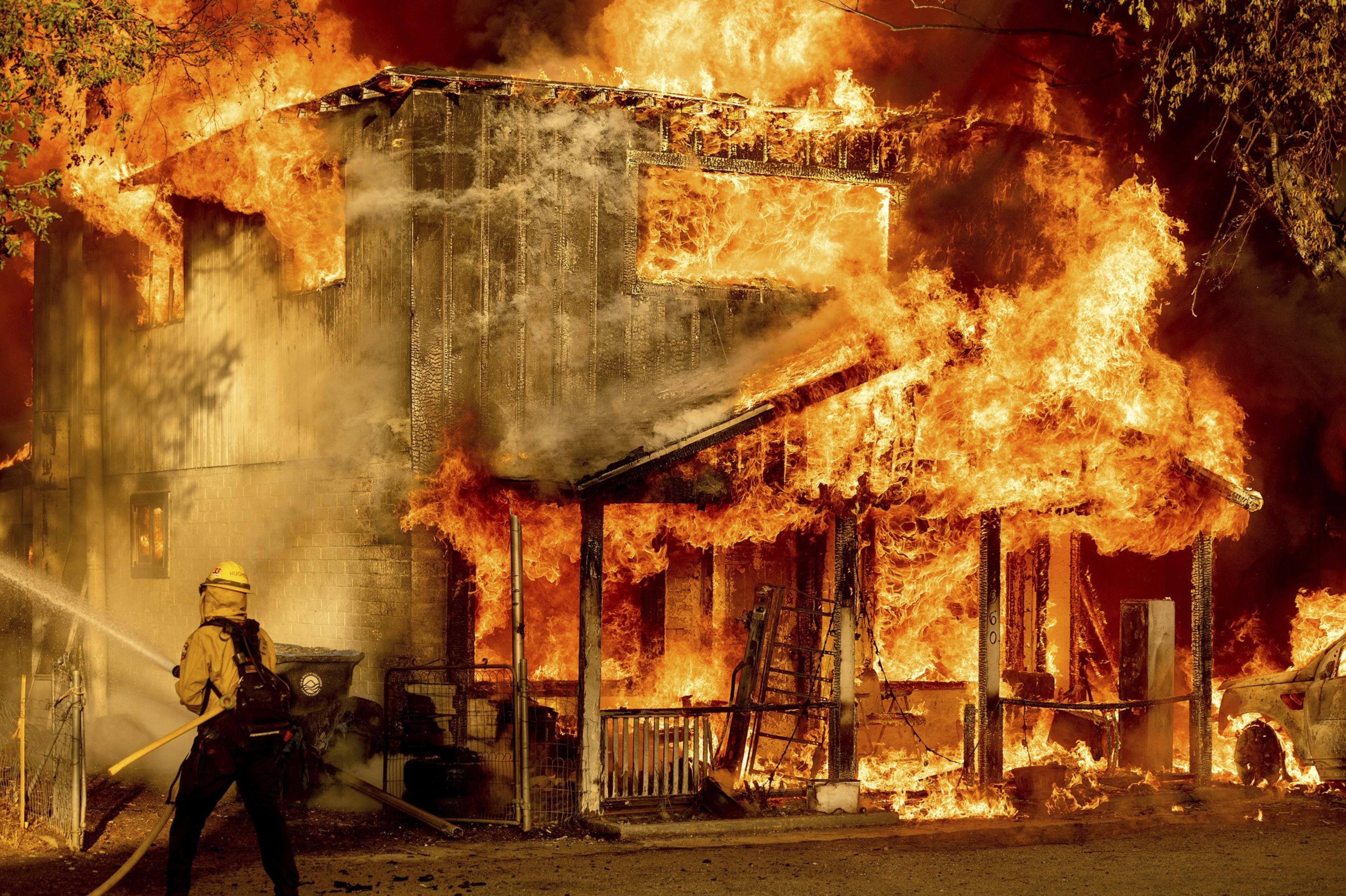 A two story home engulfed in flames