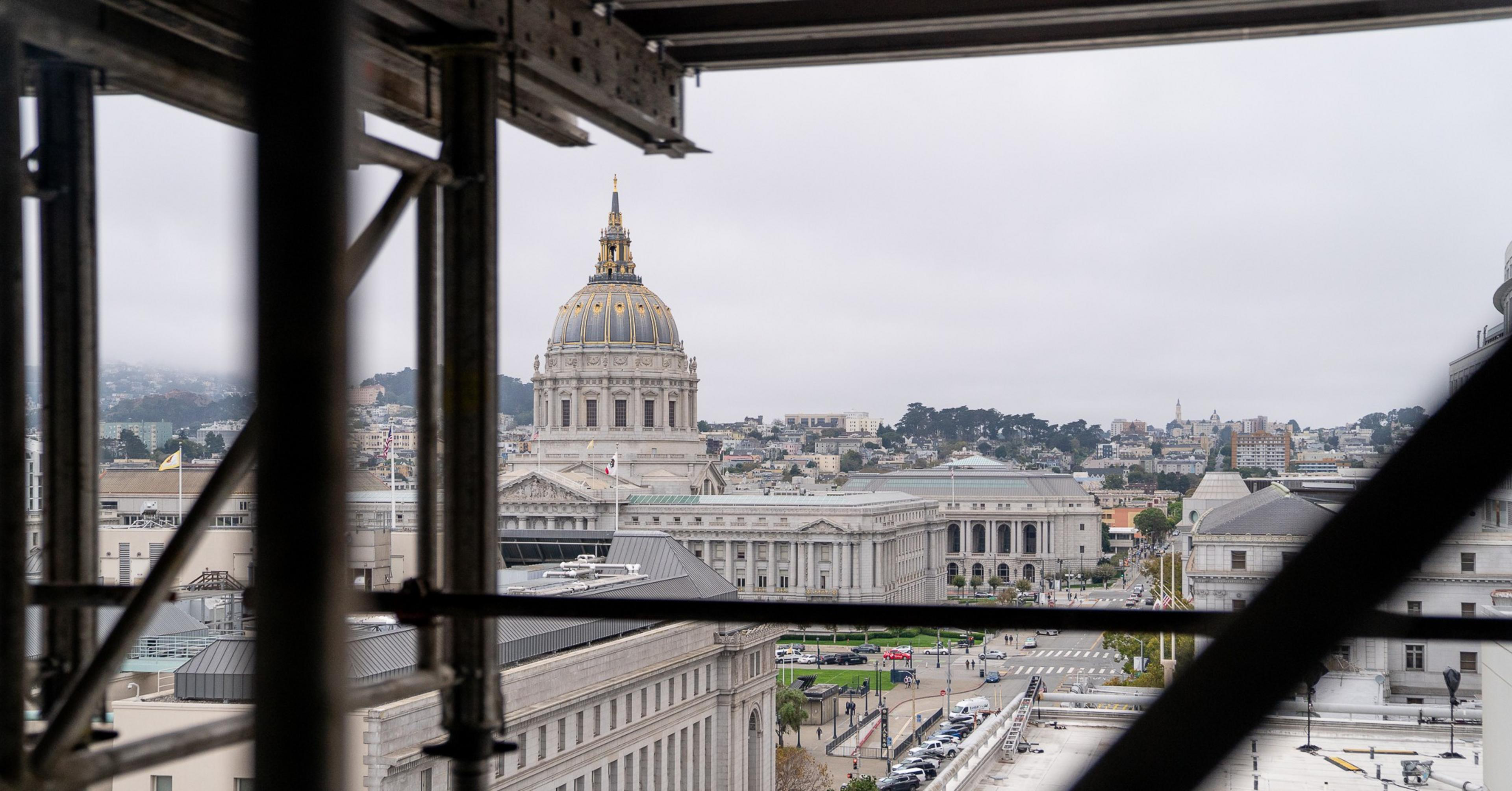San Francisco City Hall seen through a building under construction.