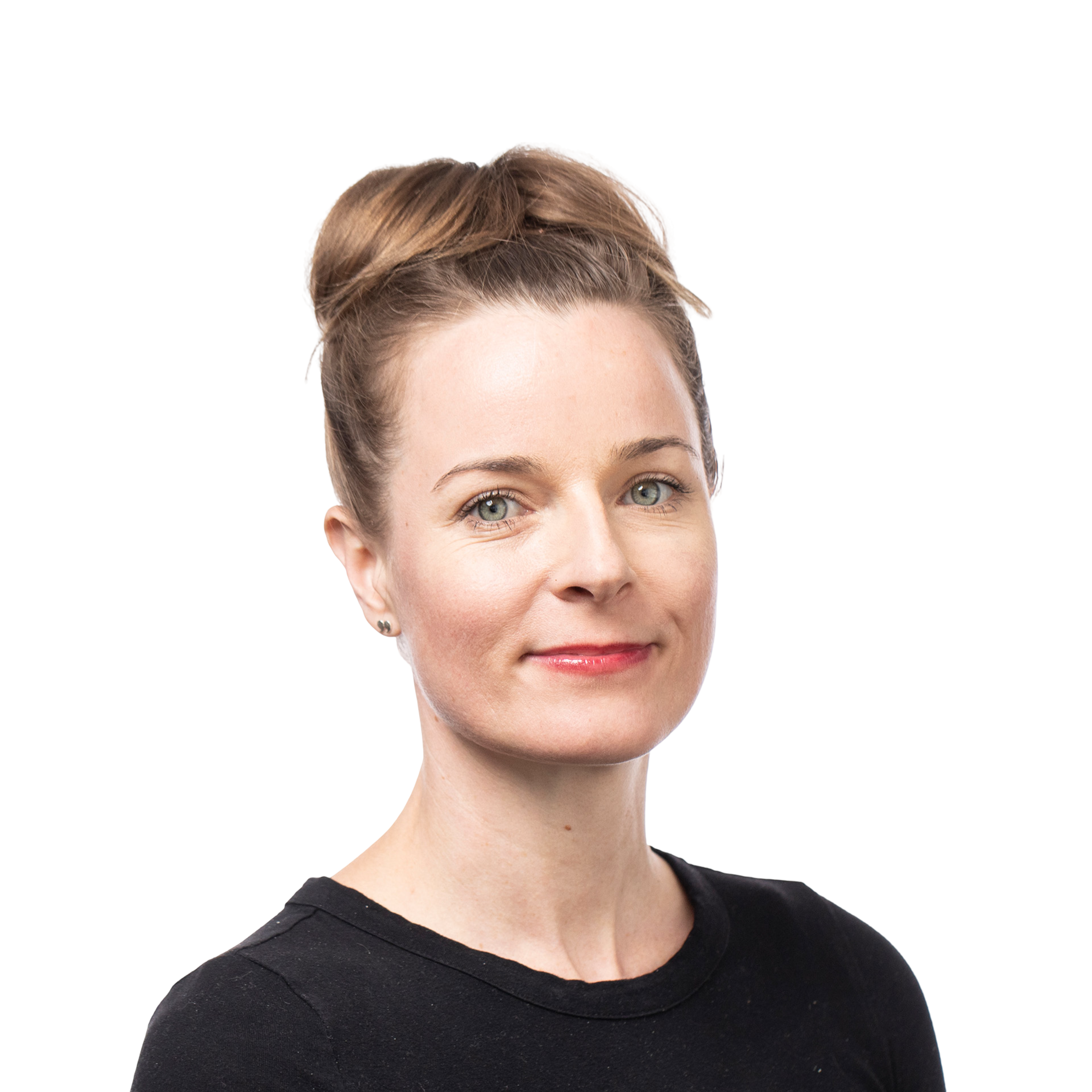 A woman with light skin, blue eyes, and brown hair styled in an updo wears a black top and has a subtle smile on her face.