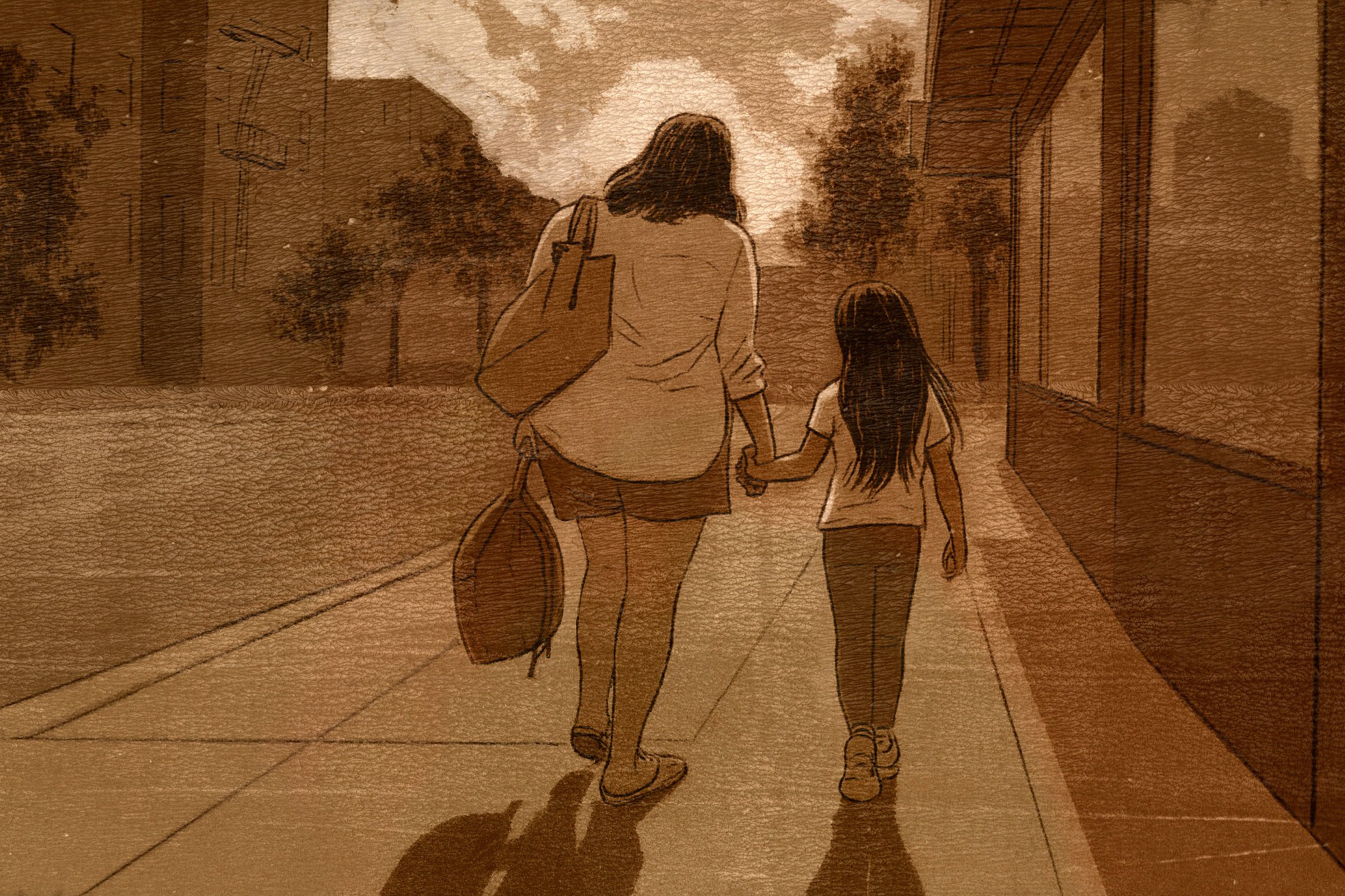 A woman and a girl walk hand in hand down a sidewalk, with the woman carrying two bags and both walking away from the viewer at sunset.