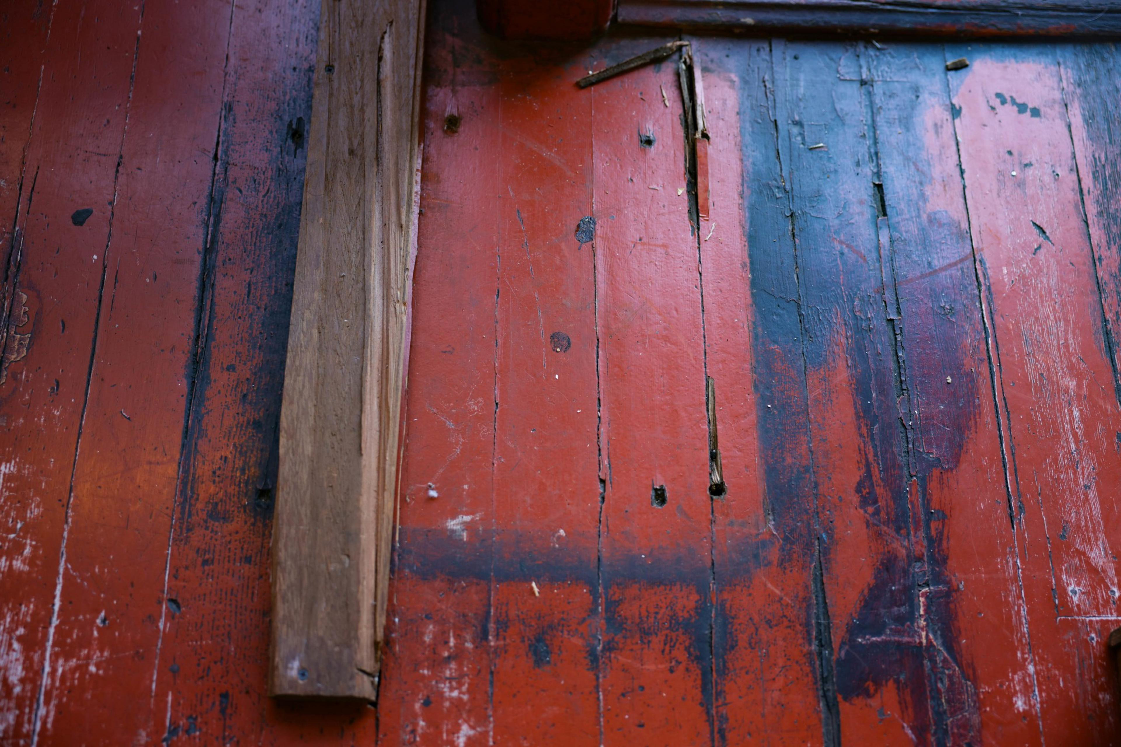 A wooden board covers a weathered floor.