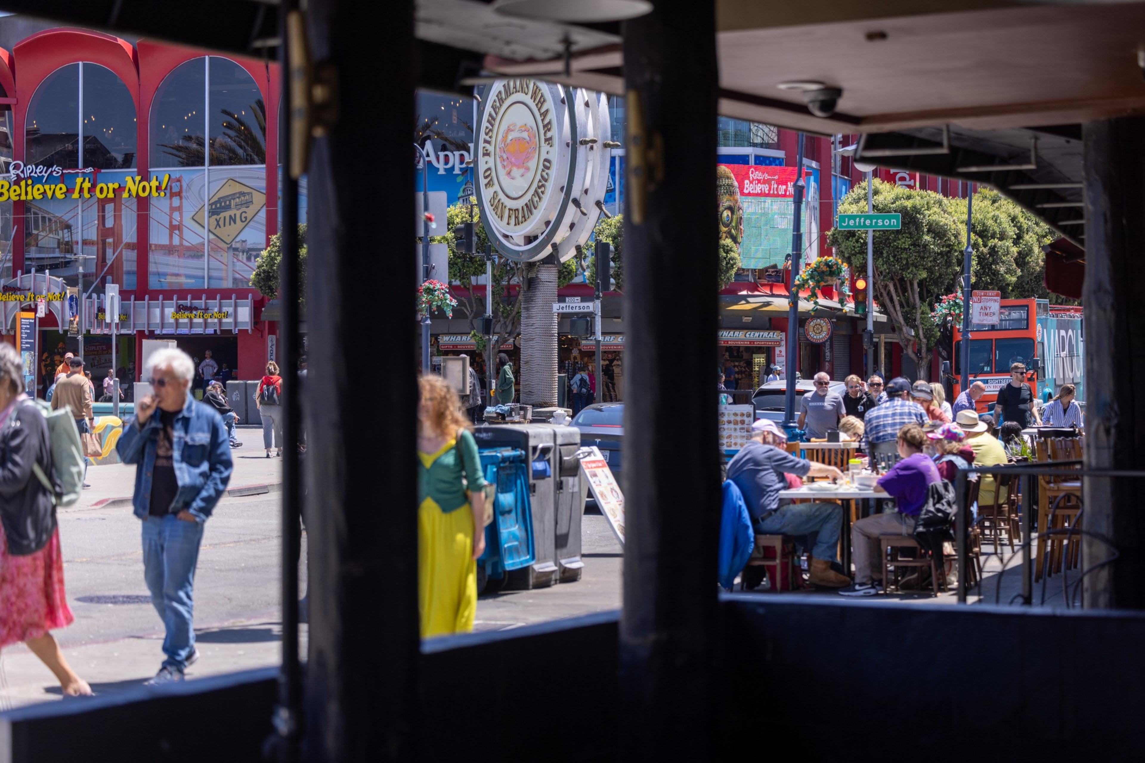 The image shows a bustling street scene with people walking and dining outdoors. There's a prominent &quot;Ripley's Believe It or Not!&quot; sign, and a large Fisherman's Wharf sign.