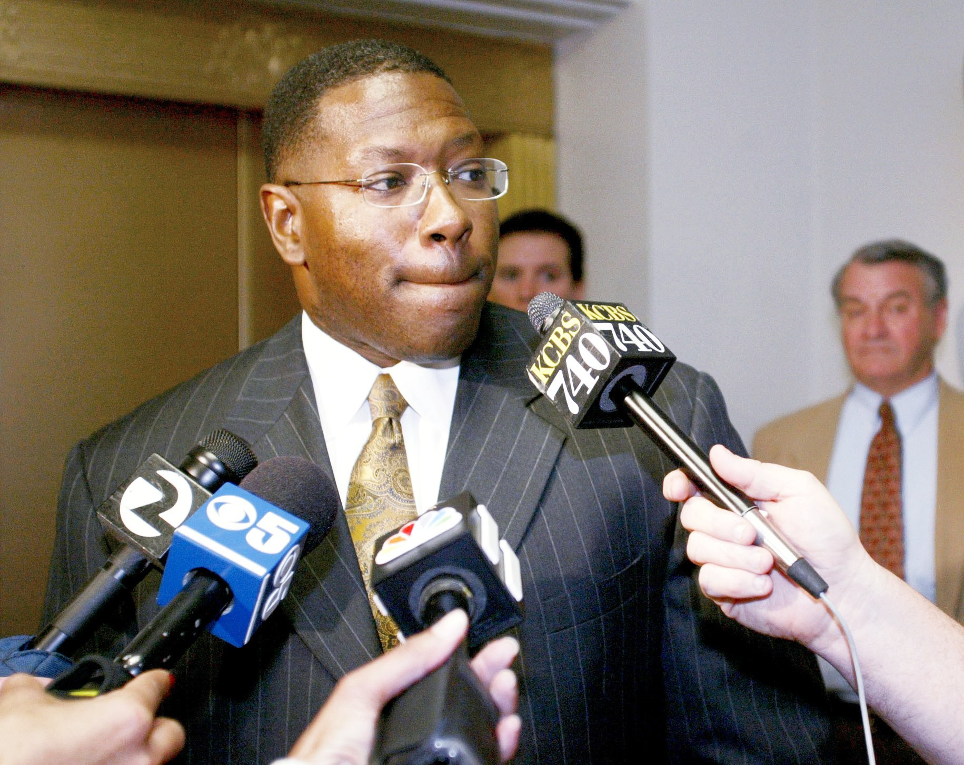A lawyer speaks to the press in a court.
