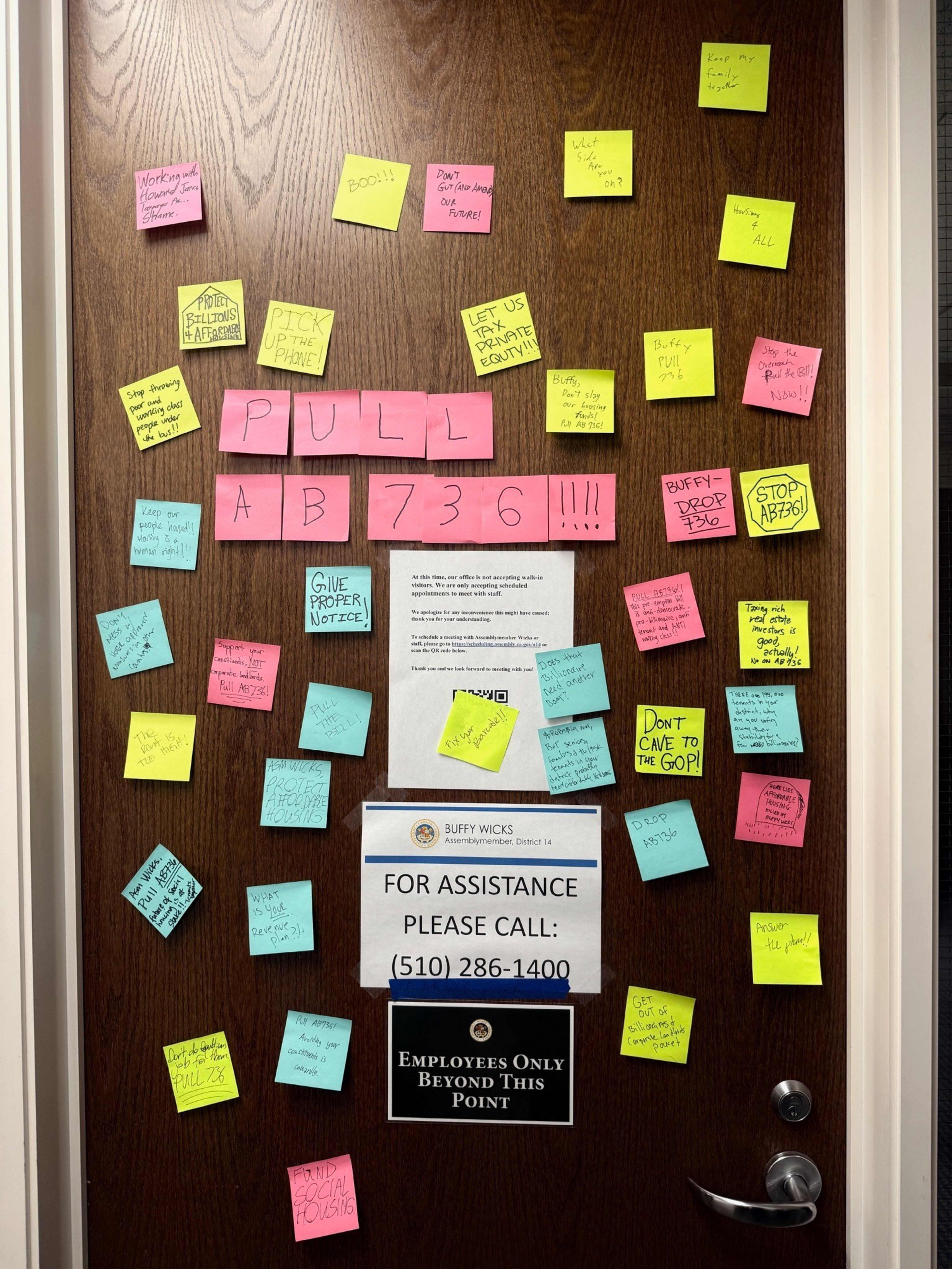 Sticky notes on a wooden door say “PULL AB736!!!!” with messages urging to stop AB736, protect equity, and contact Assemblymember Buffy Wicks.