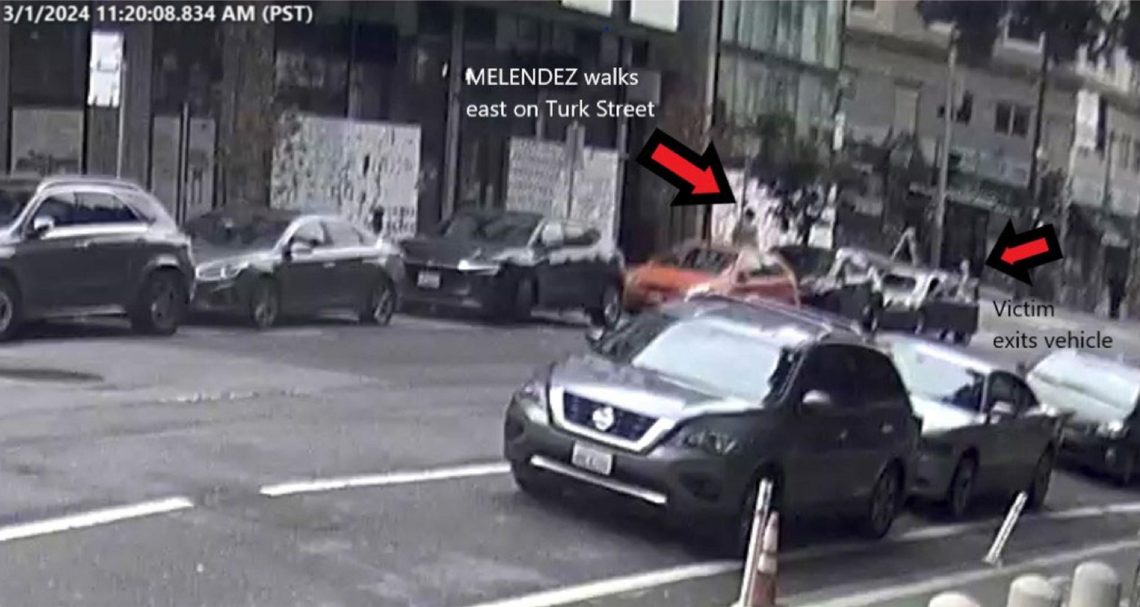 Video image of a woman walking down the street. 