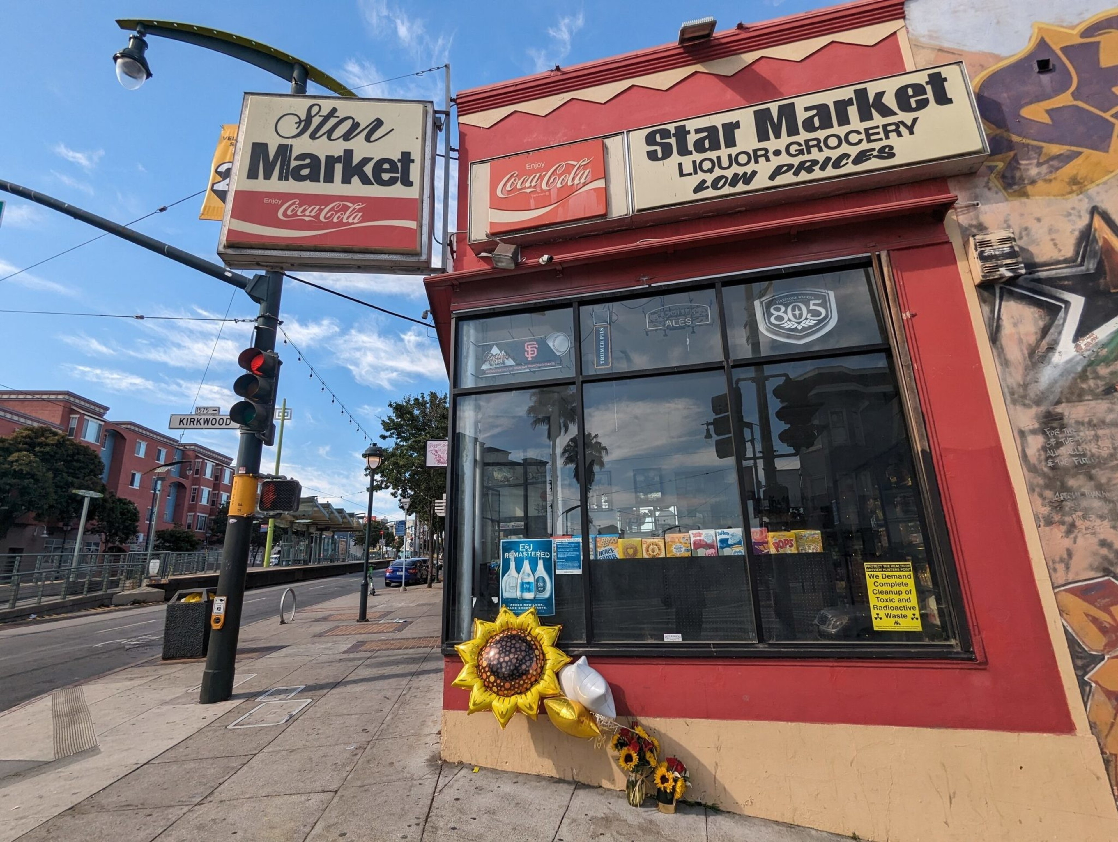 A bouquet of flowers and balloons sits Sunday morning outside the Star Market, 4400 Third St., in San Francisco's Bayview District after a fatal shooting Saturday night that police are investigating as a homicide. | George Kelly/The Standard