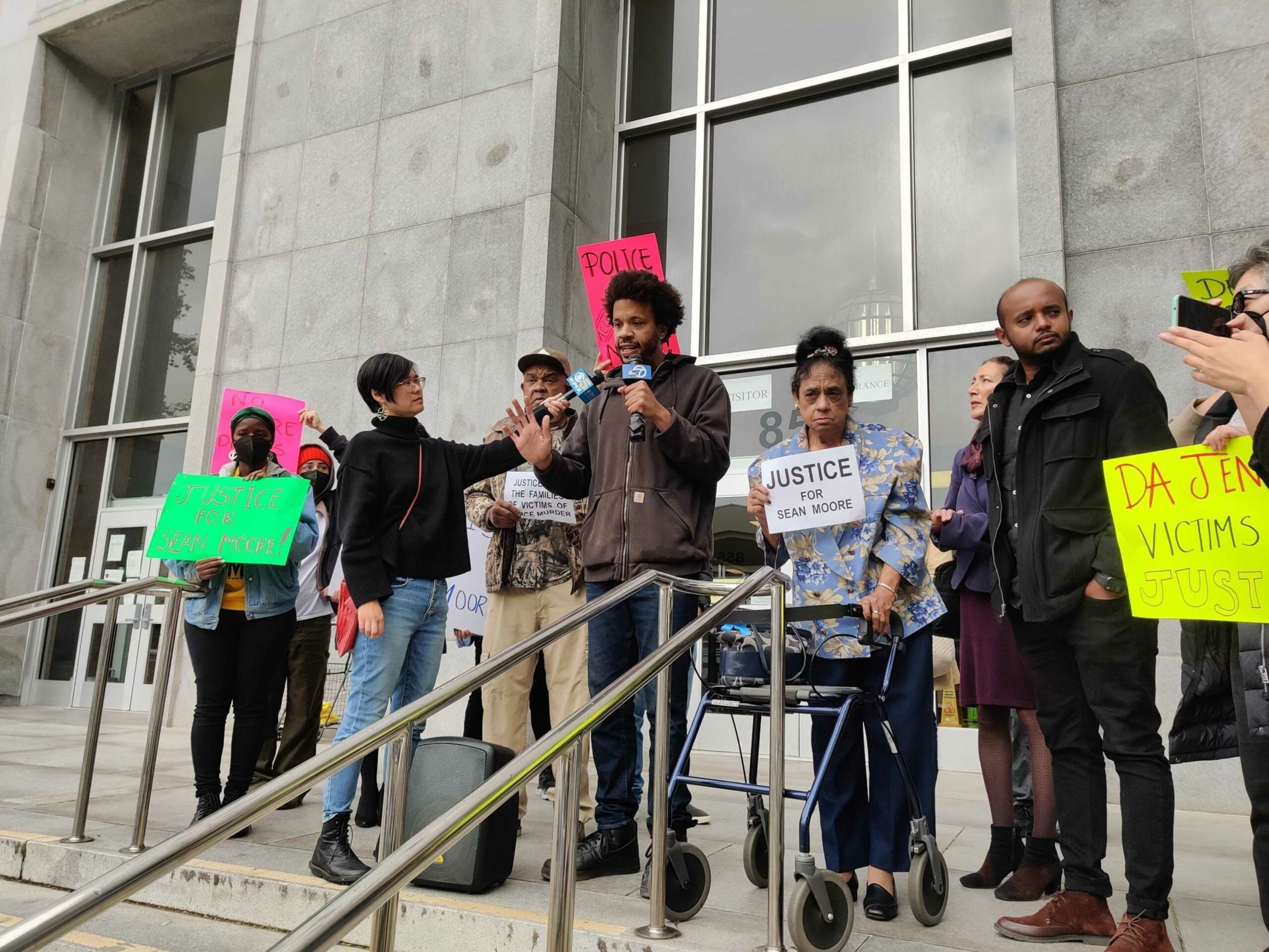 Cleo Moore, Sean Moore's mother, holds a justice for Sean Moore sign on the steps of the San Francisco Hall of Justice on May 26, 2023. | Noah Baustin