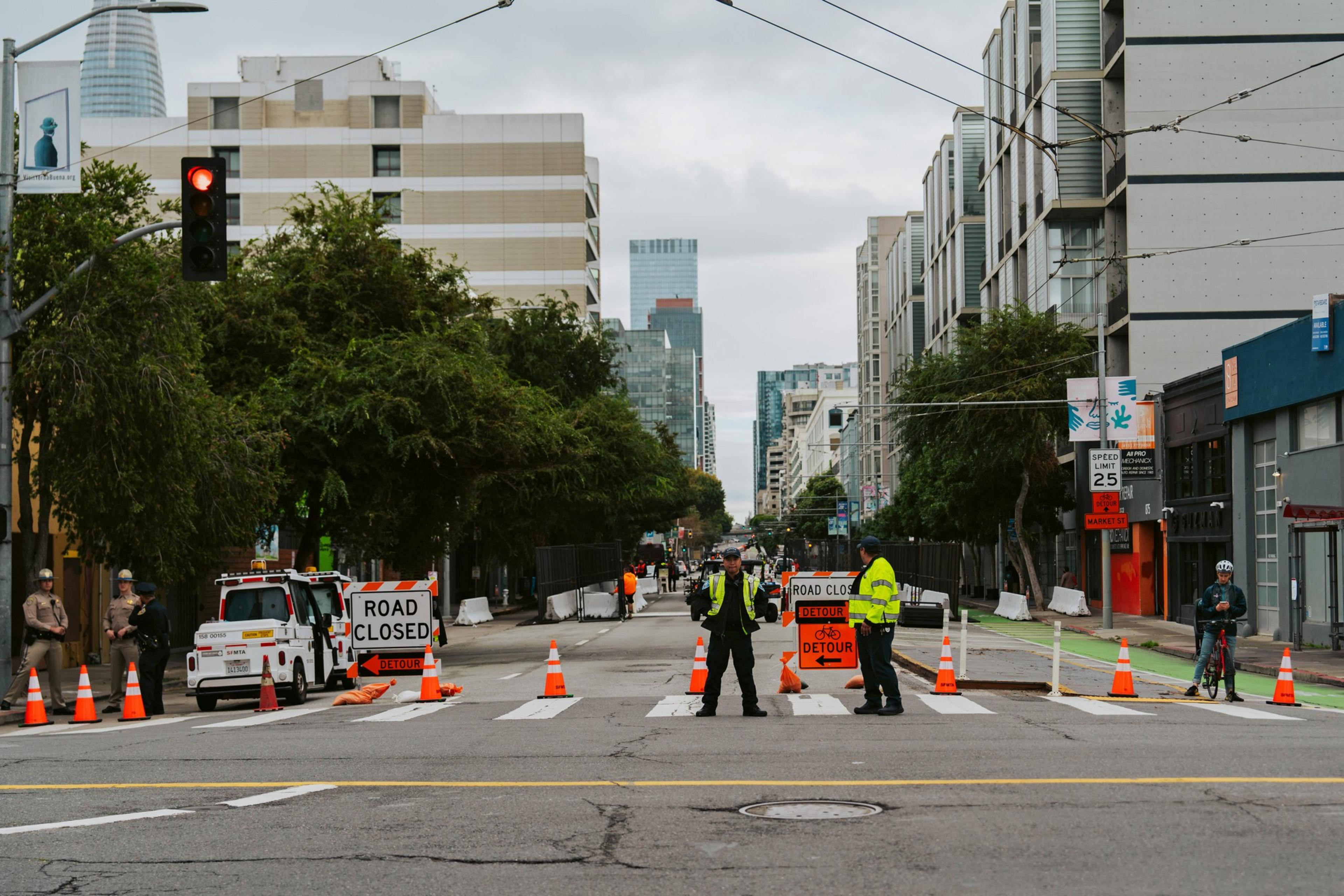 Law enforcement stand in the middle of a closed street
