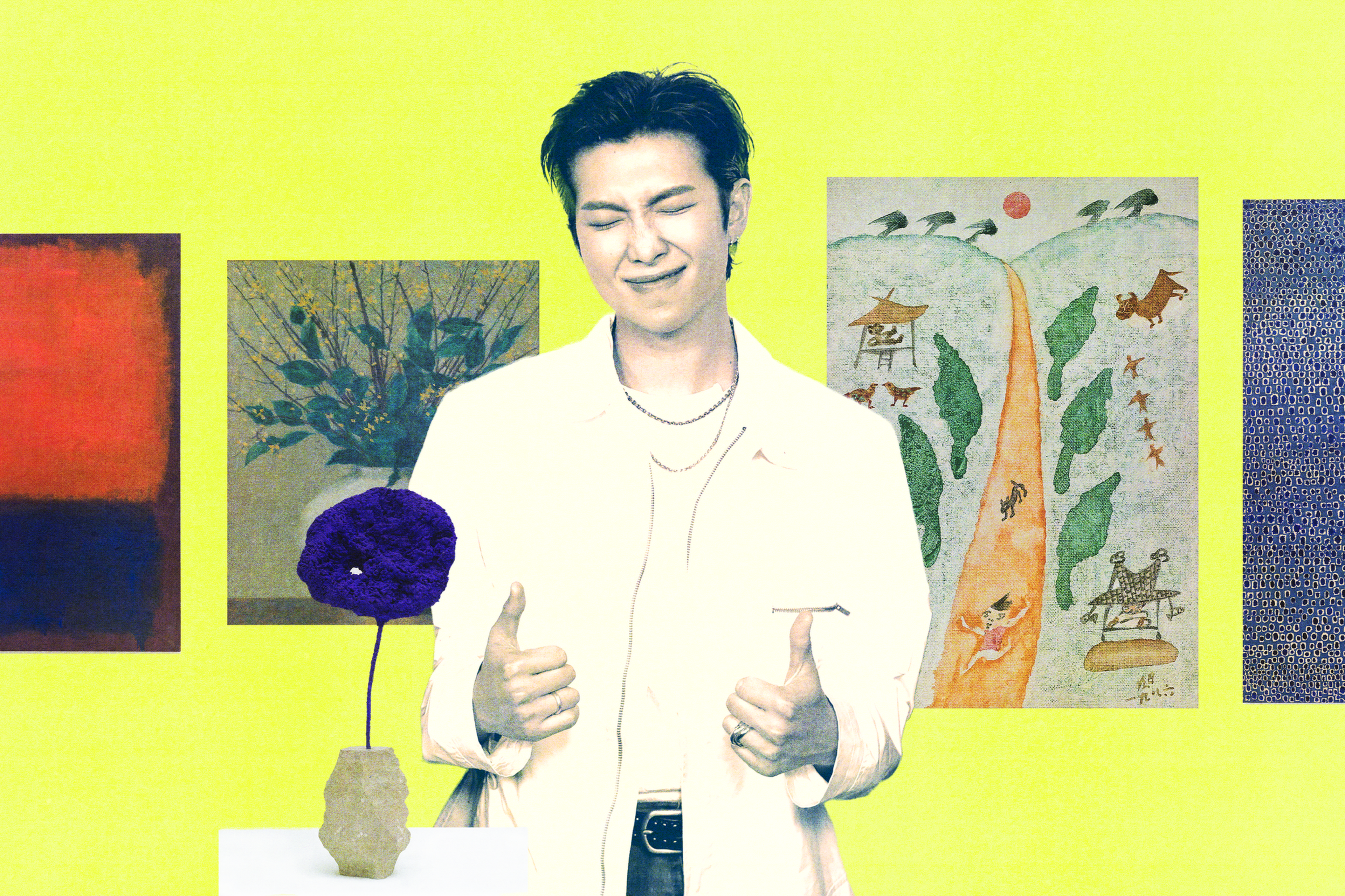 A man in a white shirt smiles with eyes closed and gives two thumbs up, standing against a yellow wall decorated with colorful paintings.