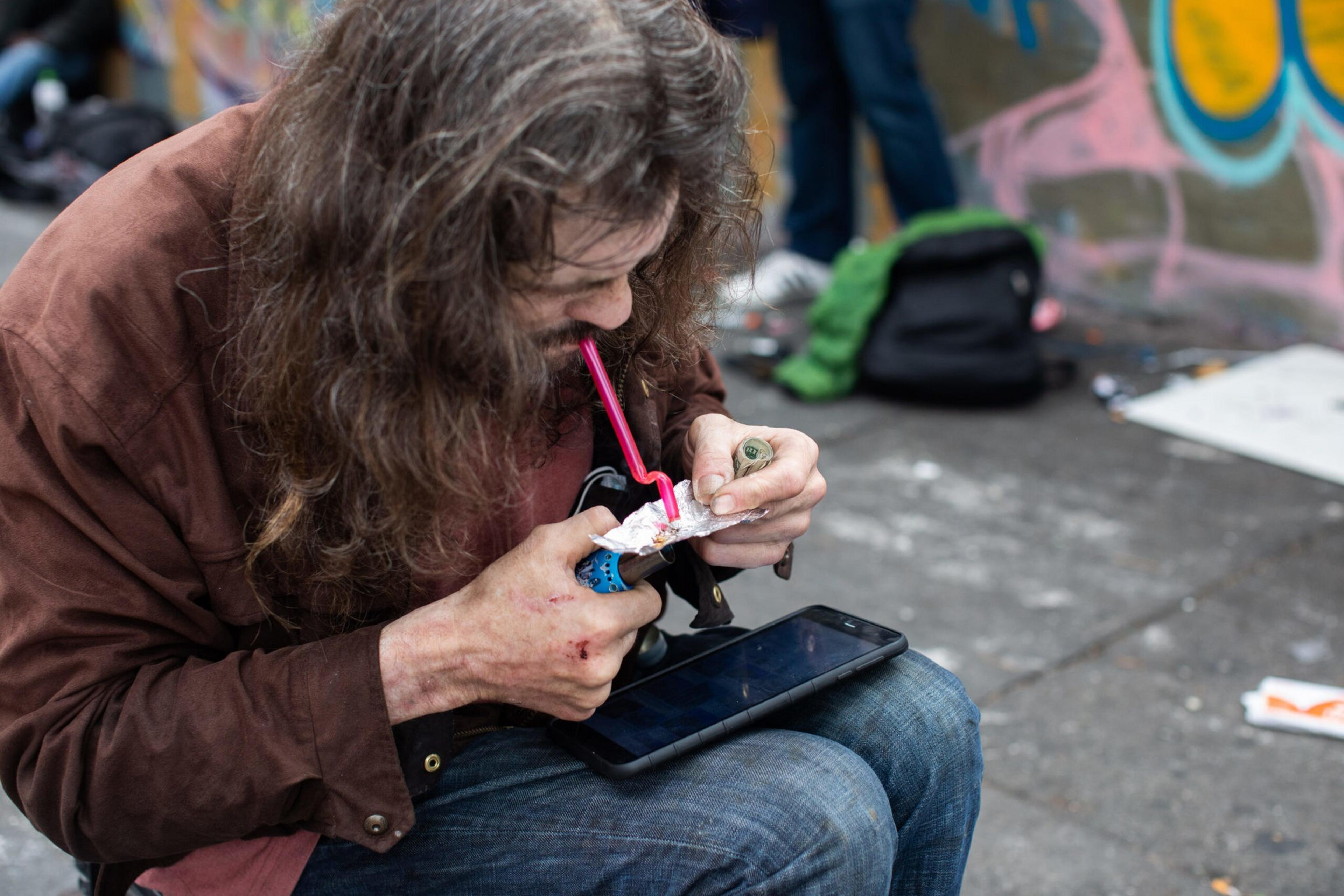 A man using drugs on the street