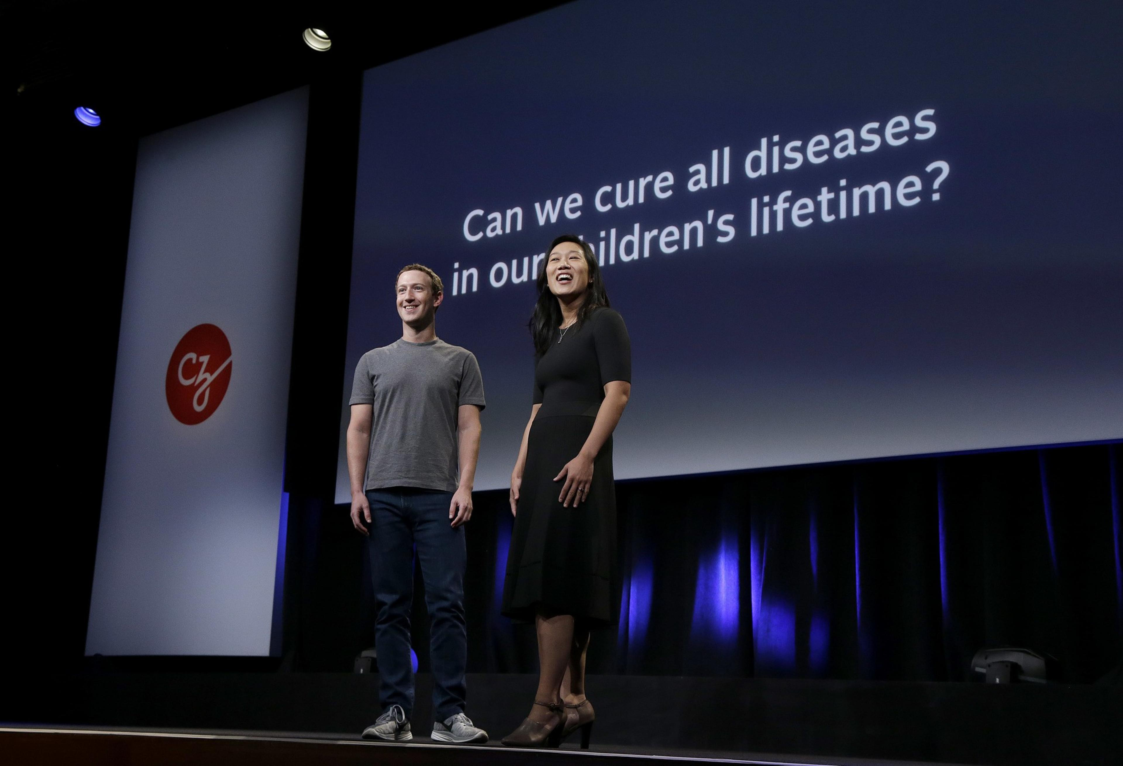 In this Tuesday, Sept. 20, 2016, photo, Facebook CEO Mark Zuckerberg and his wife, Priscilla Chan, prepare for a speech in San Francisco. Zuckerberg and Chan have a new lofty goal: to cure, manage or eradicate all disease by the end of this century. To this end, the Chan Zuckerberg Initiative, the couple's philanthropic organization, is committing significant financial resources over the next decade to help accelerate basic science research. (AP Photo/Jeff Chiu)