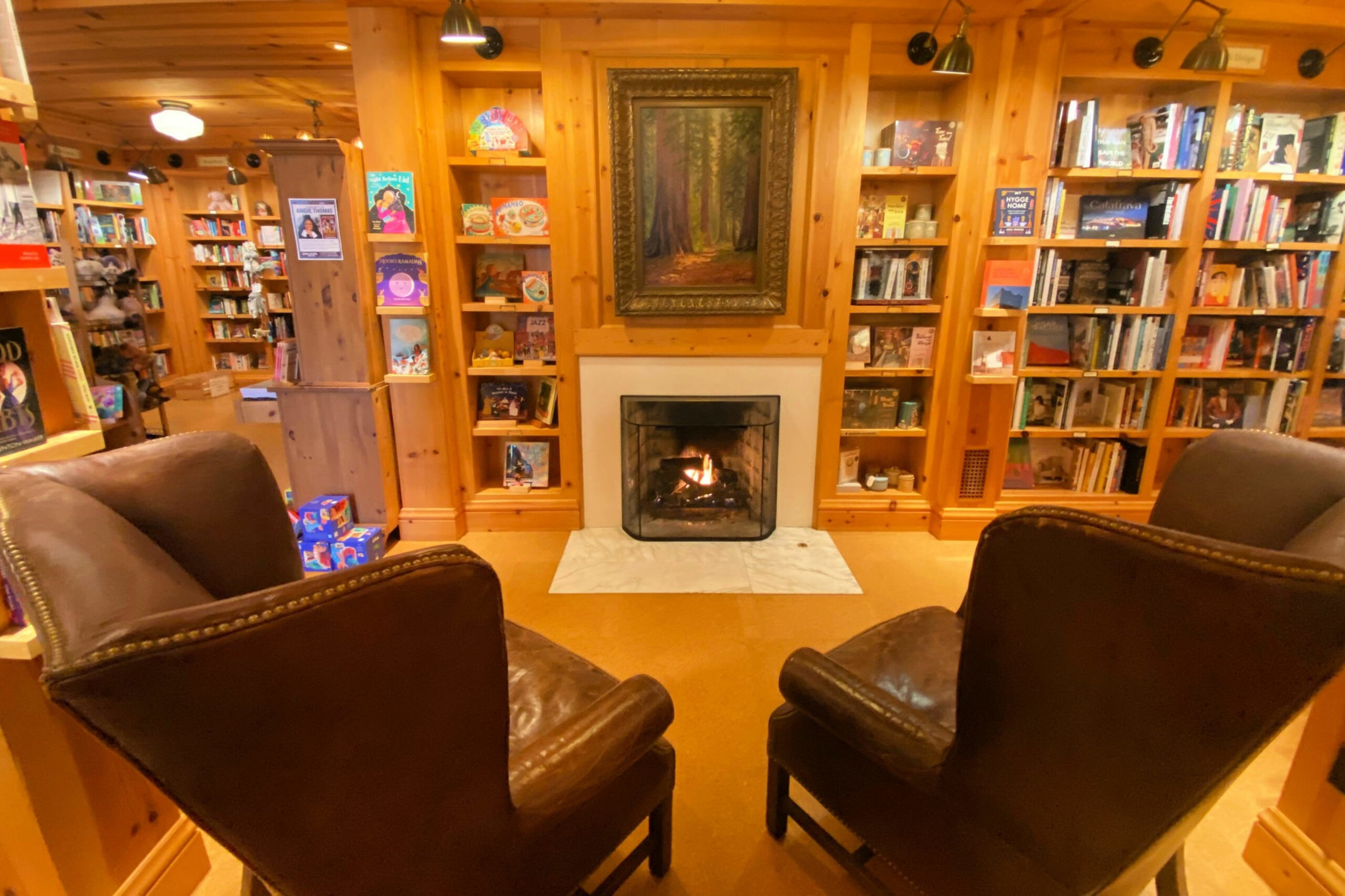 Two empty chairs in front of book shelves. 
