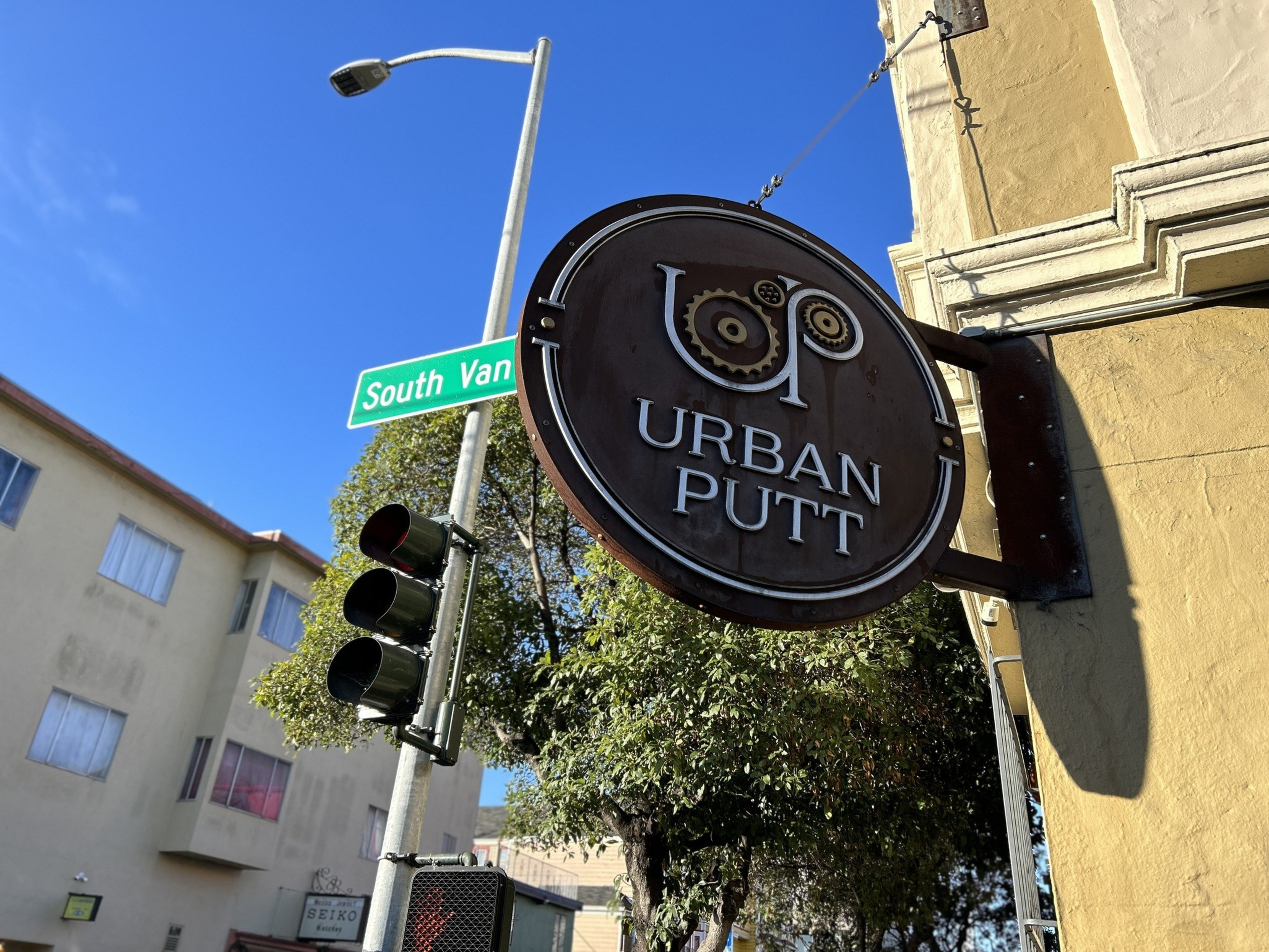 An exterior sign by day for a mini golf course