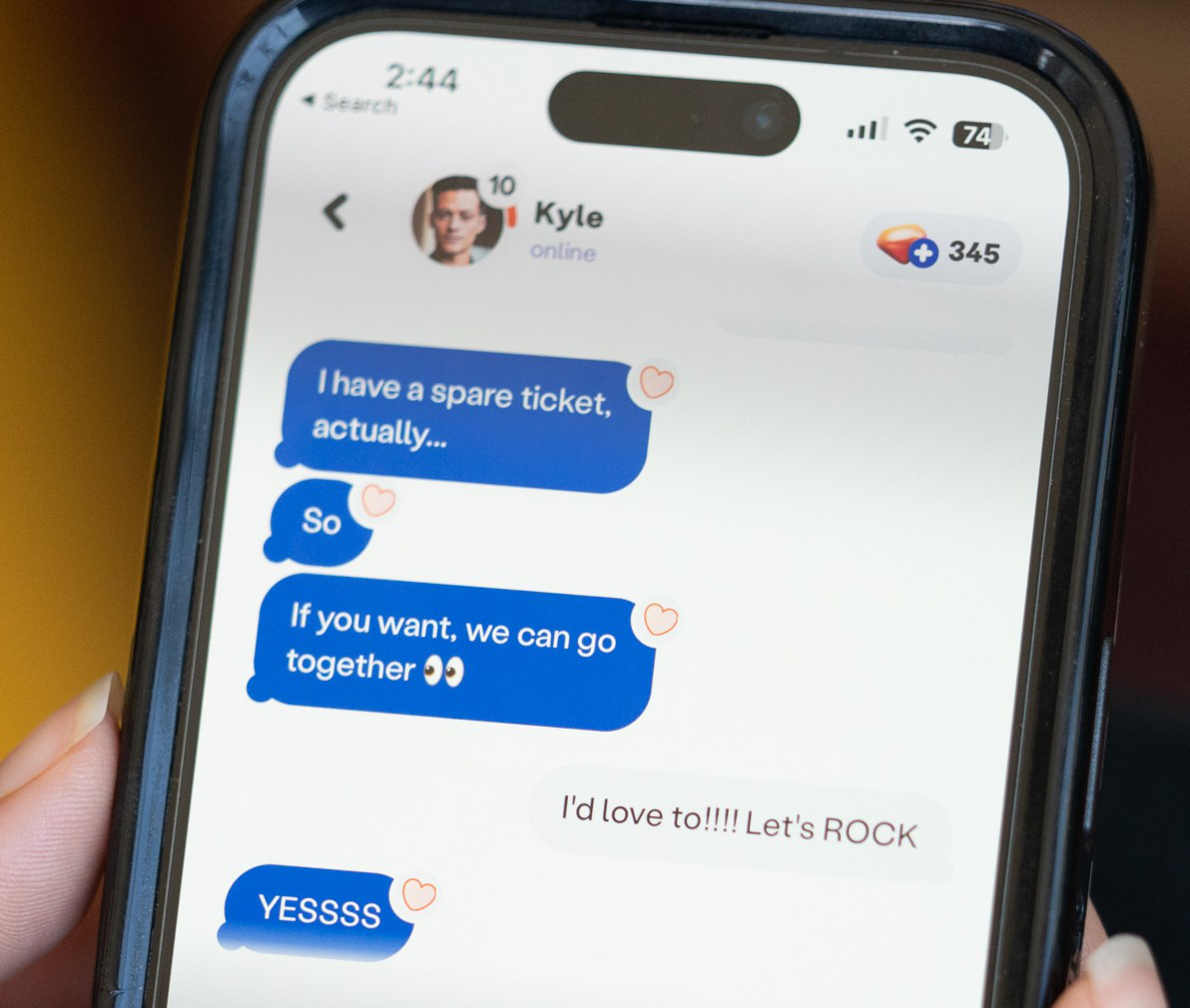 Kyle messages, offering a spare ticket and suggesting they go together; the reply is enthusiastic, saying, "I'd love to!!! Let's ROCK," followed by "YESSSS."