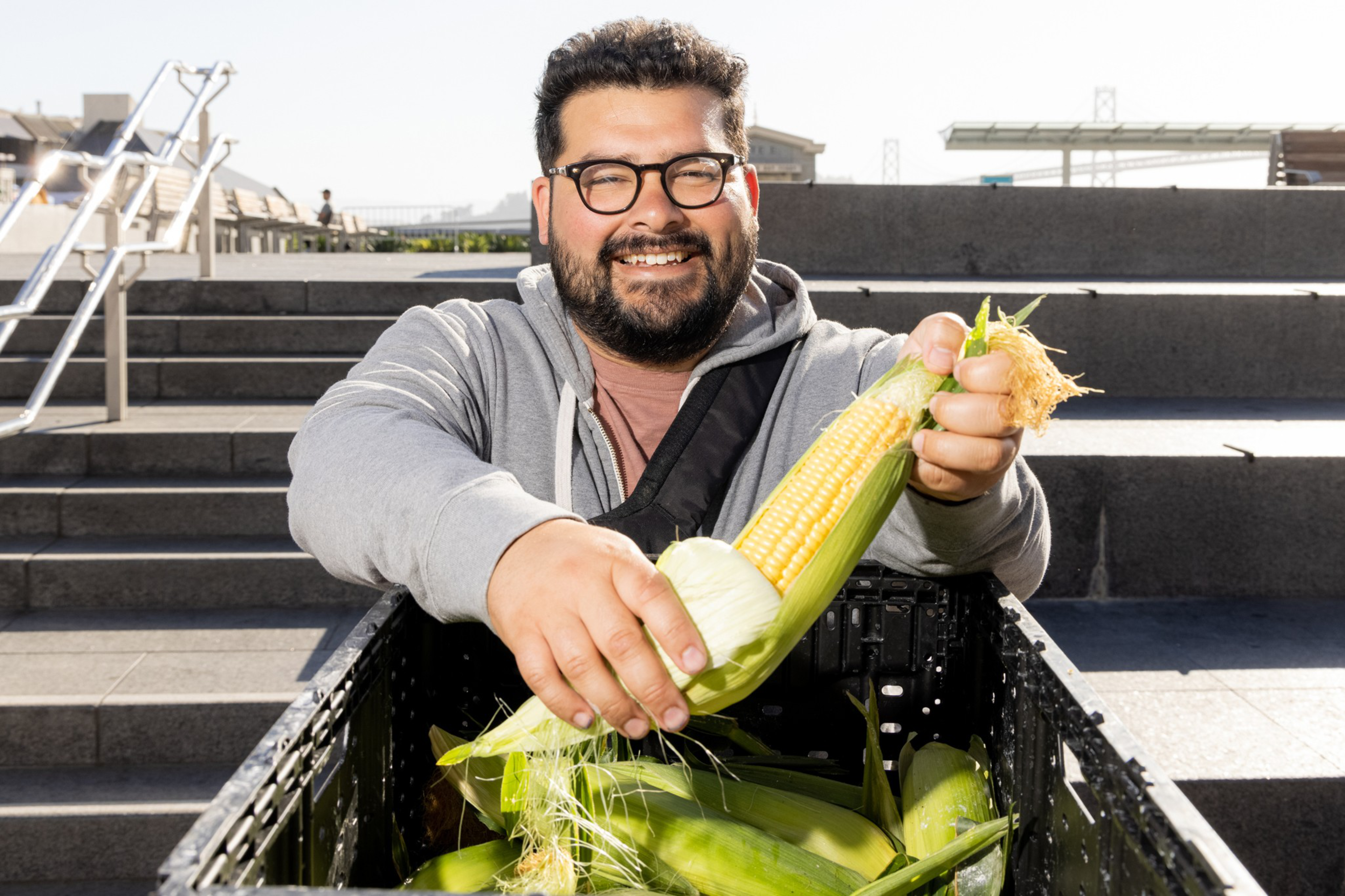 Chef Nico Pena of Octavia holding Brentwood corn