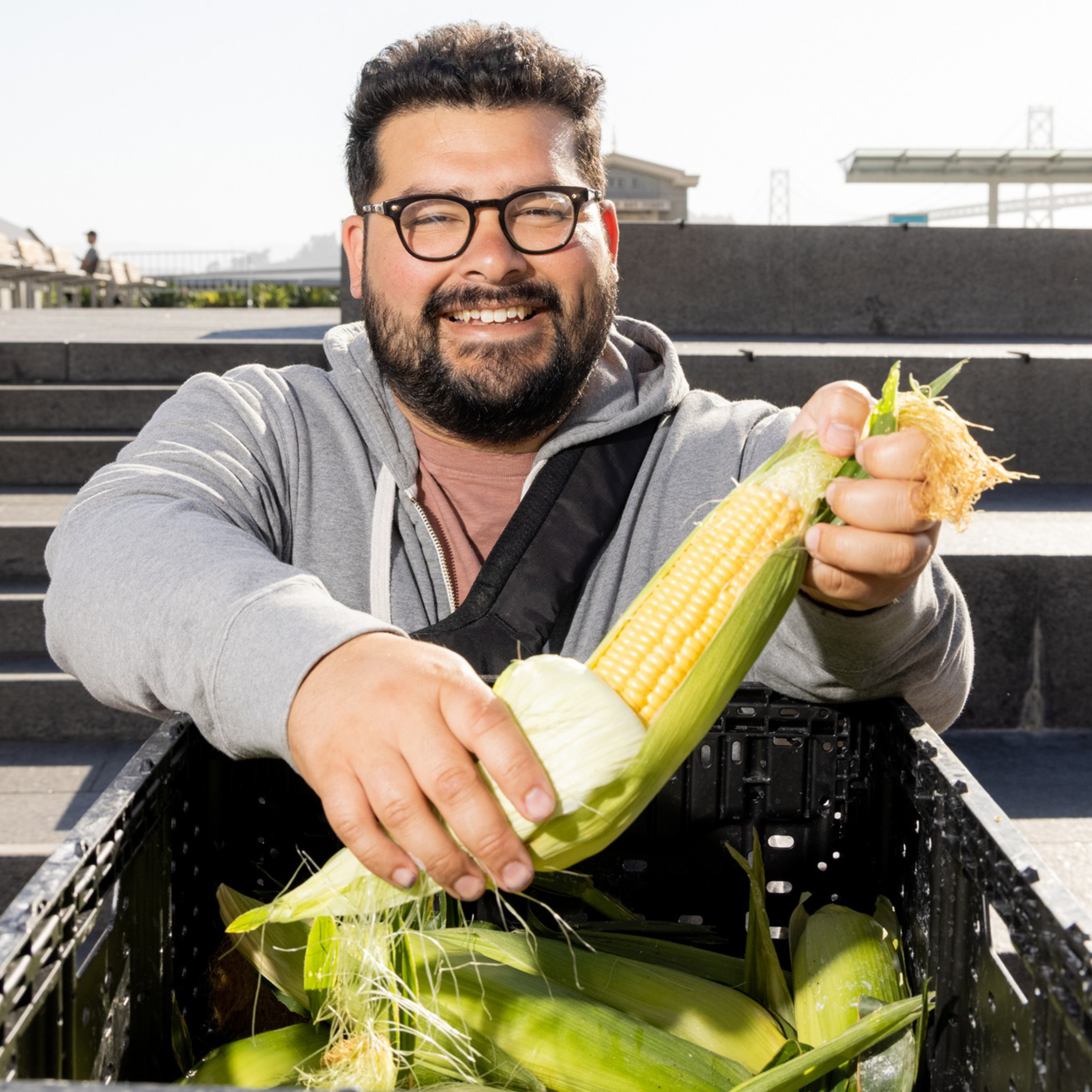 Chef Nico Pena of Octavia holding Brentwood corn