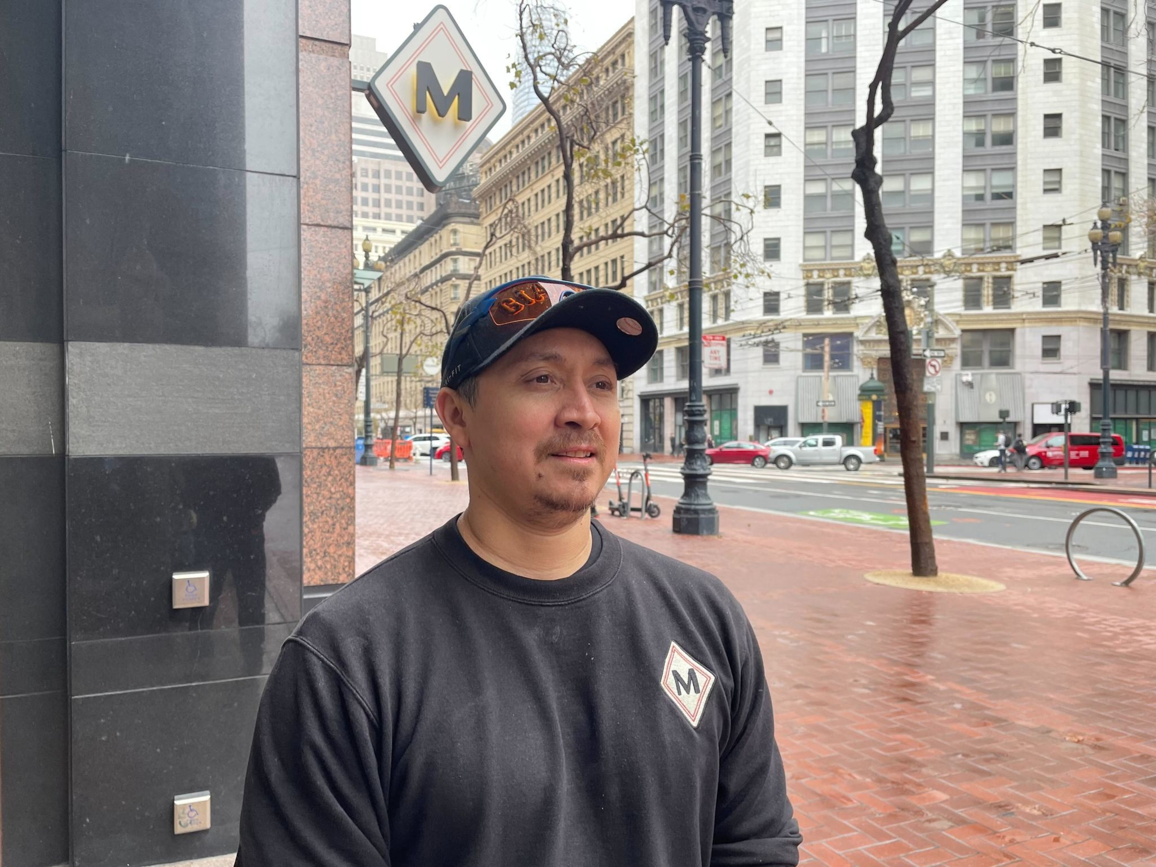 A man stands on a sidewalk.