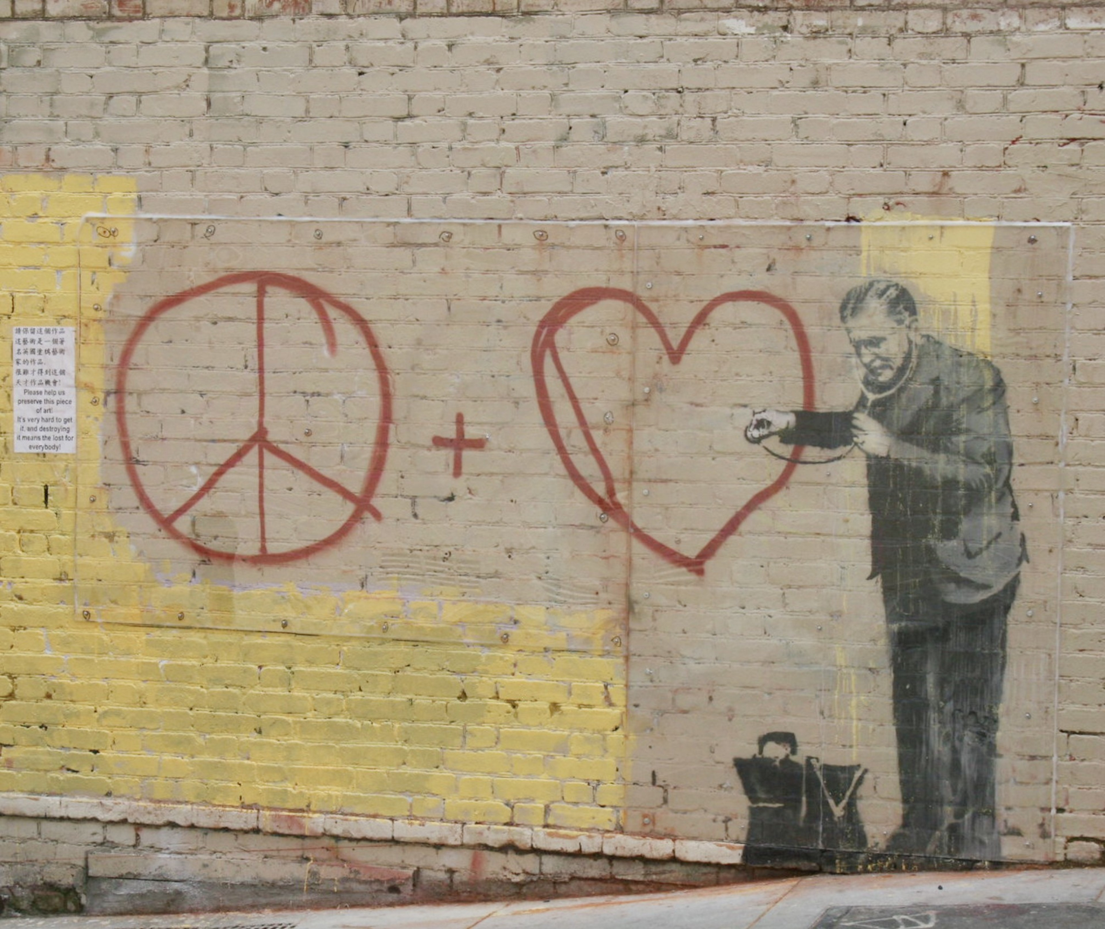 A graffiti painting is seen on a brick wall.