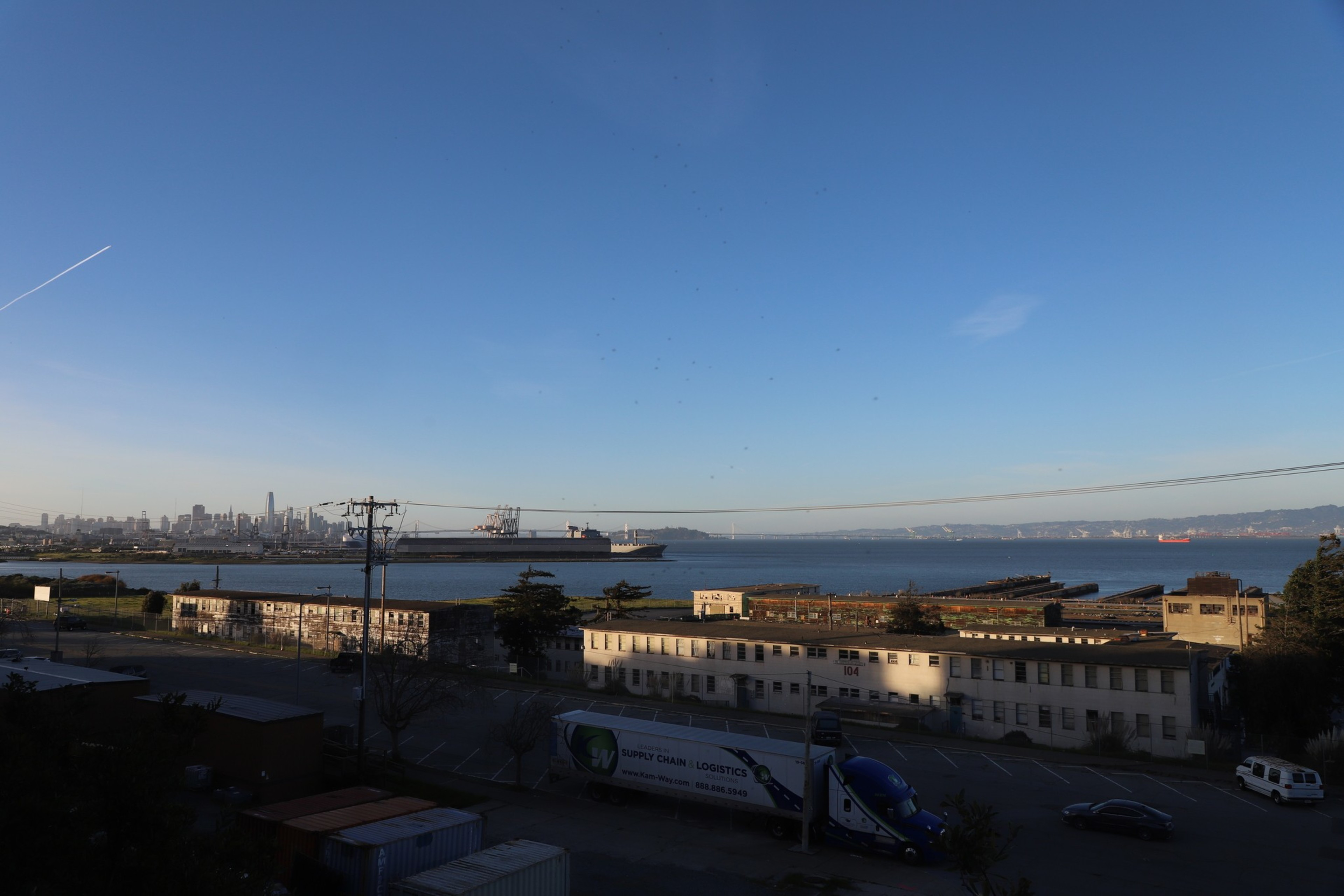 A shipyard is seen in the distance in a photo.