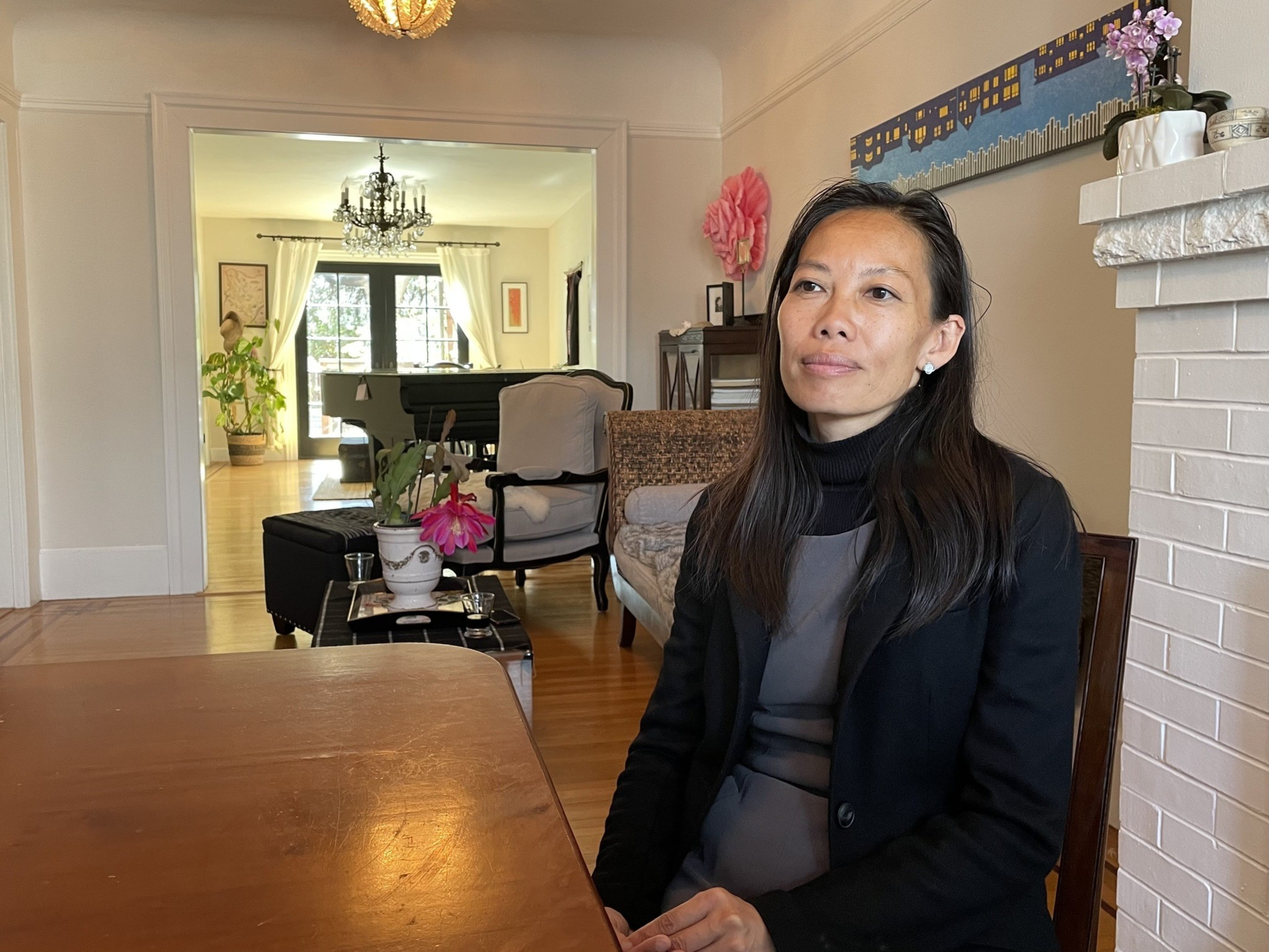 A woman sits at a table.