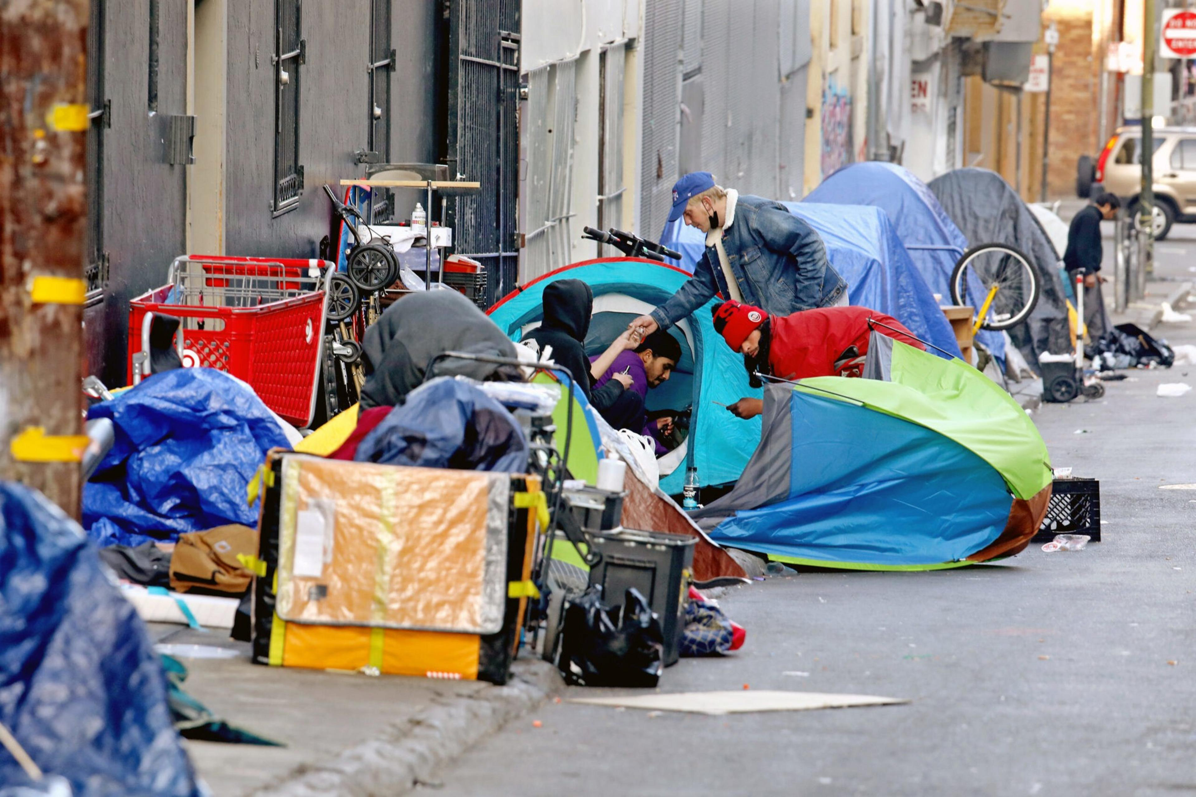 A line of multicolored tents on a city street.