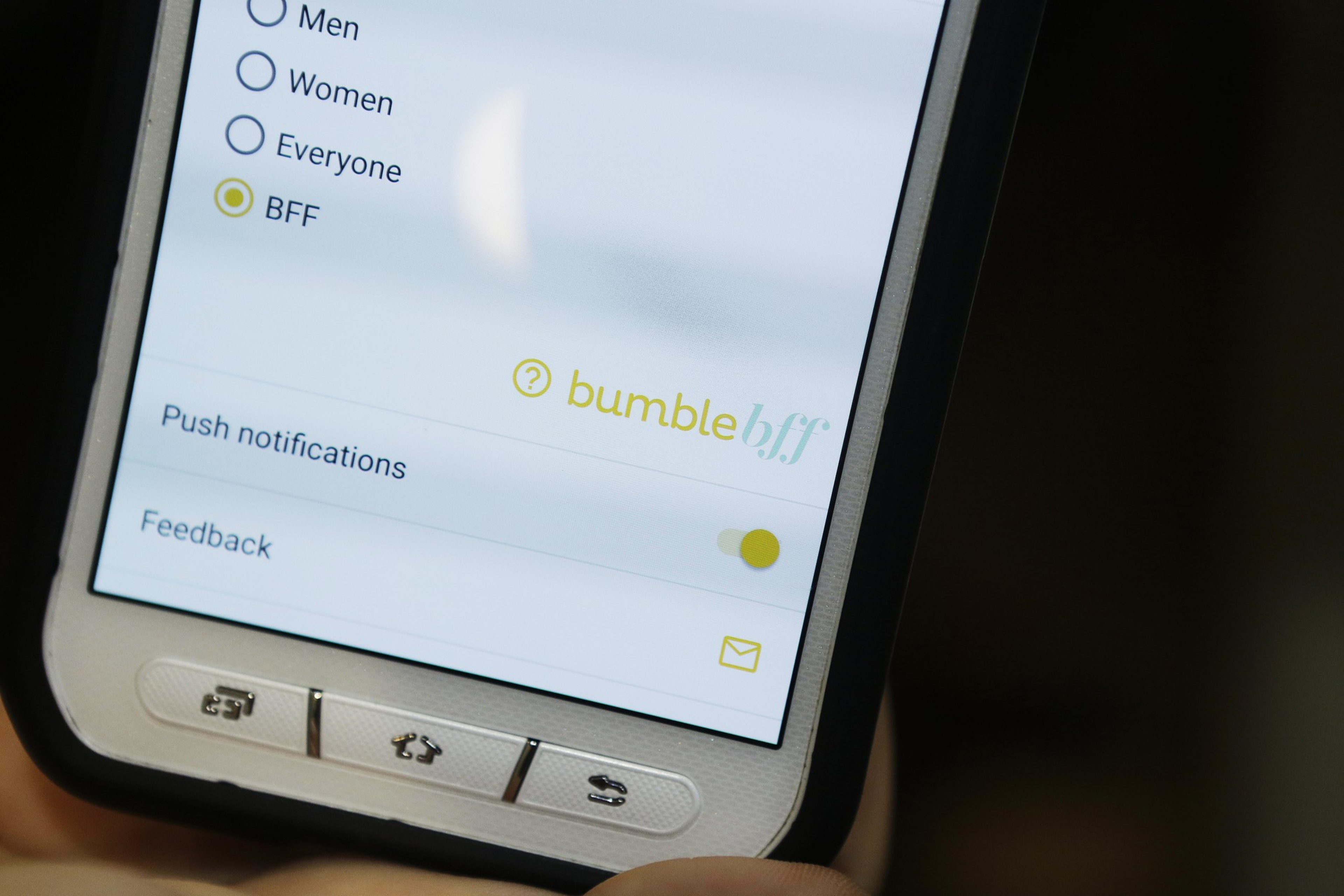 A tight image of the bottom of a cell phone detail of the mobile photo app, Bumble BFF, where people can find friends or in some cases, BFFs.