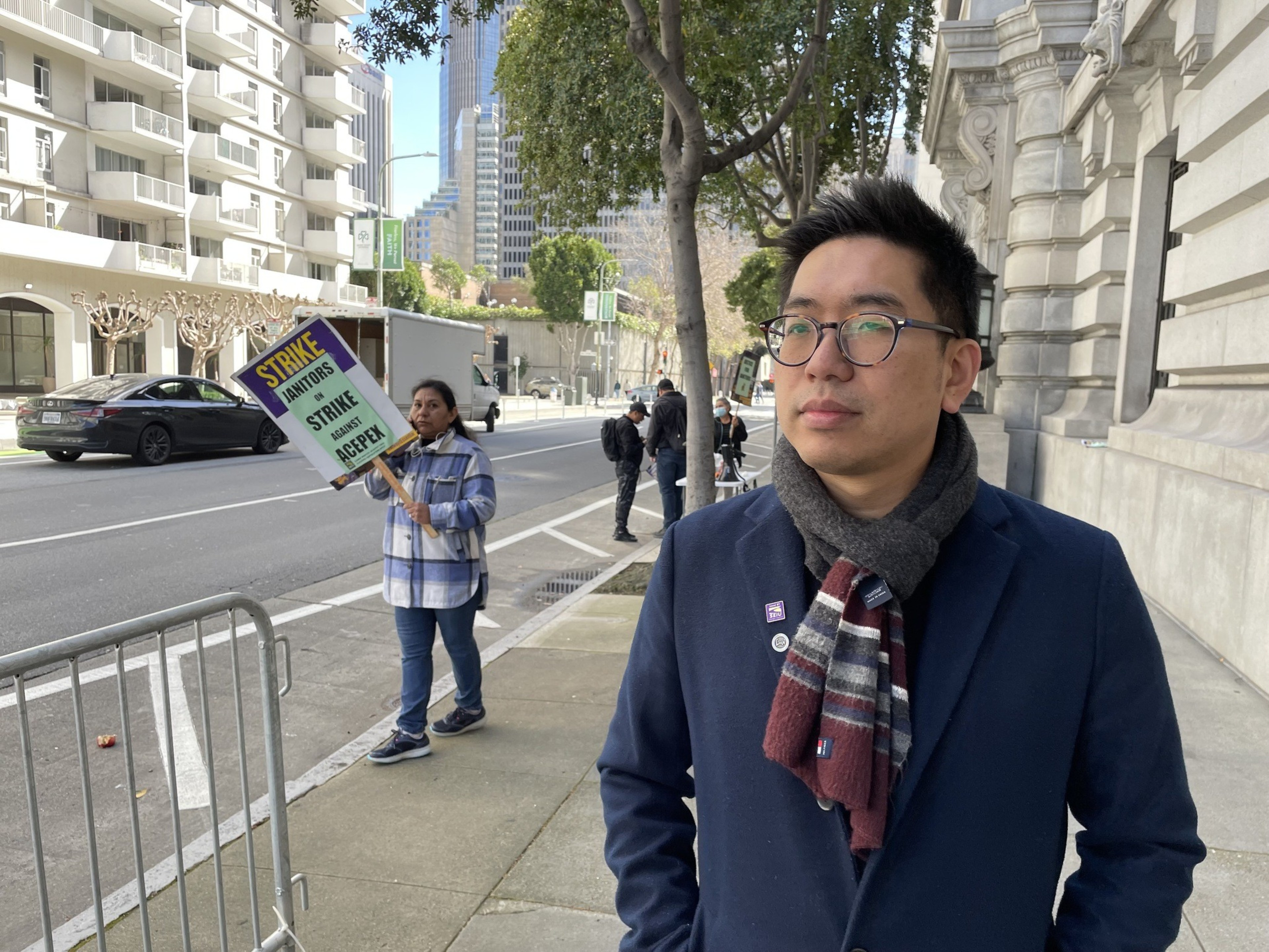 A man stands on the sidewalk.