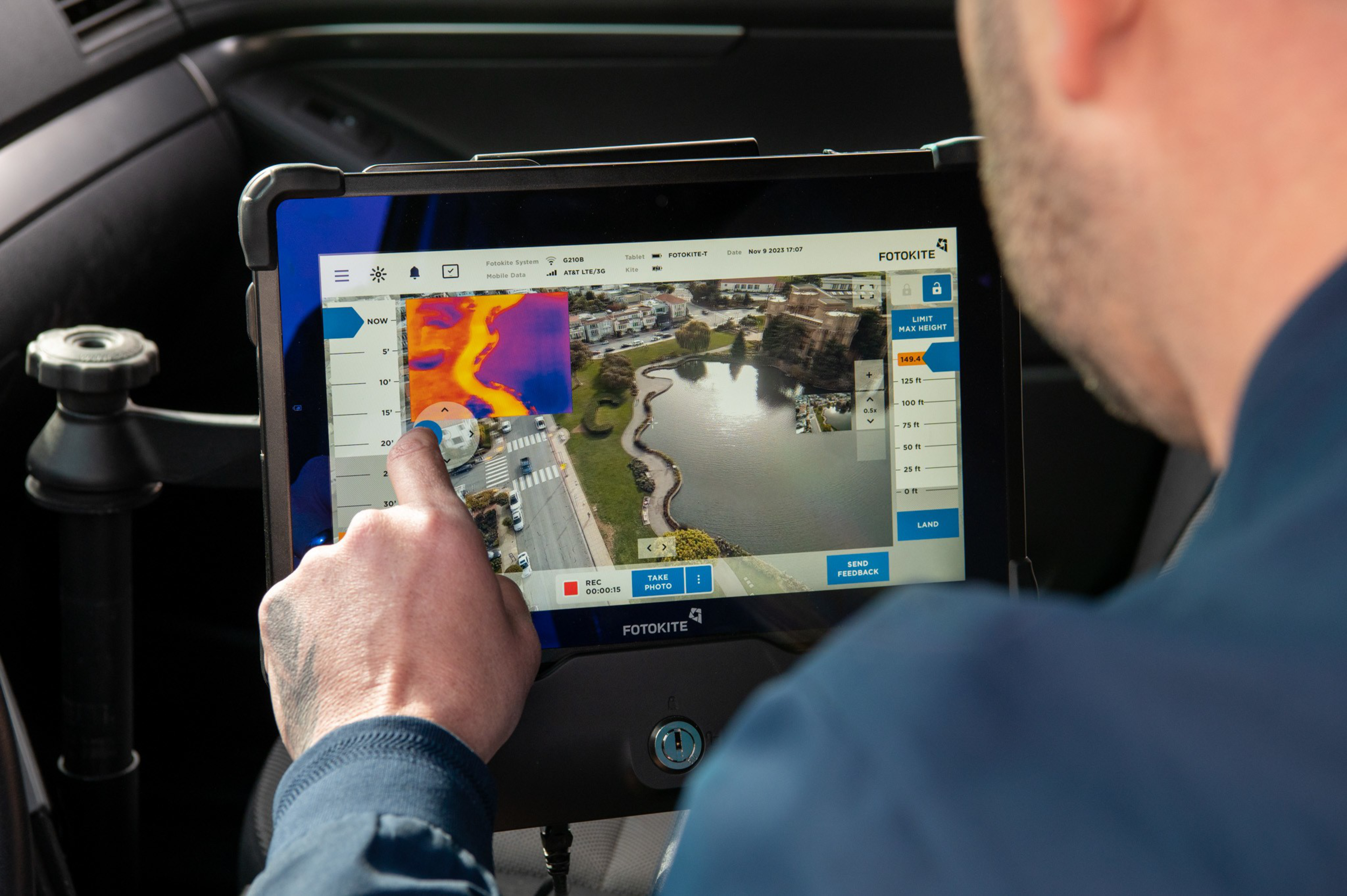 A person is using a tablet displaying a map and thermal image.