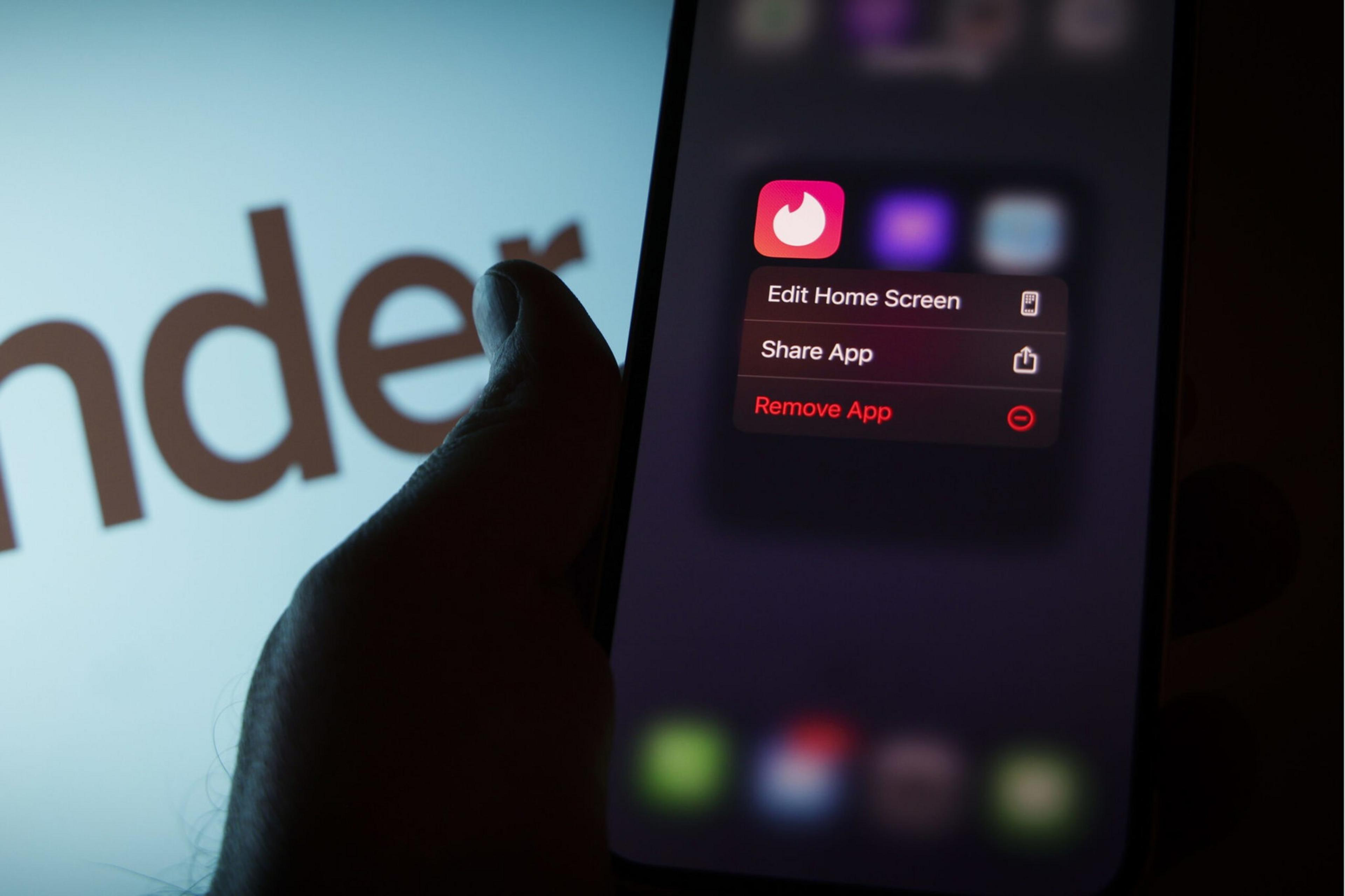 A red and white flame logo is seen on the screen of a cellphone