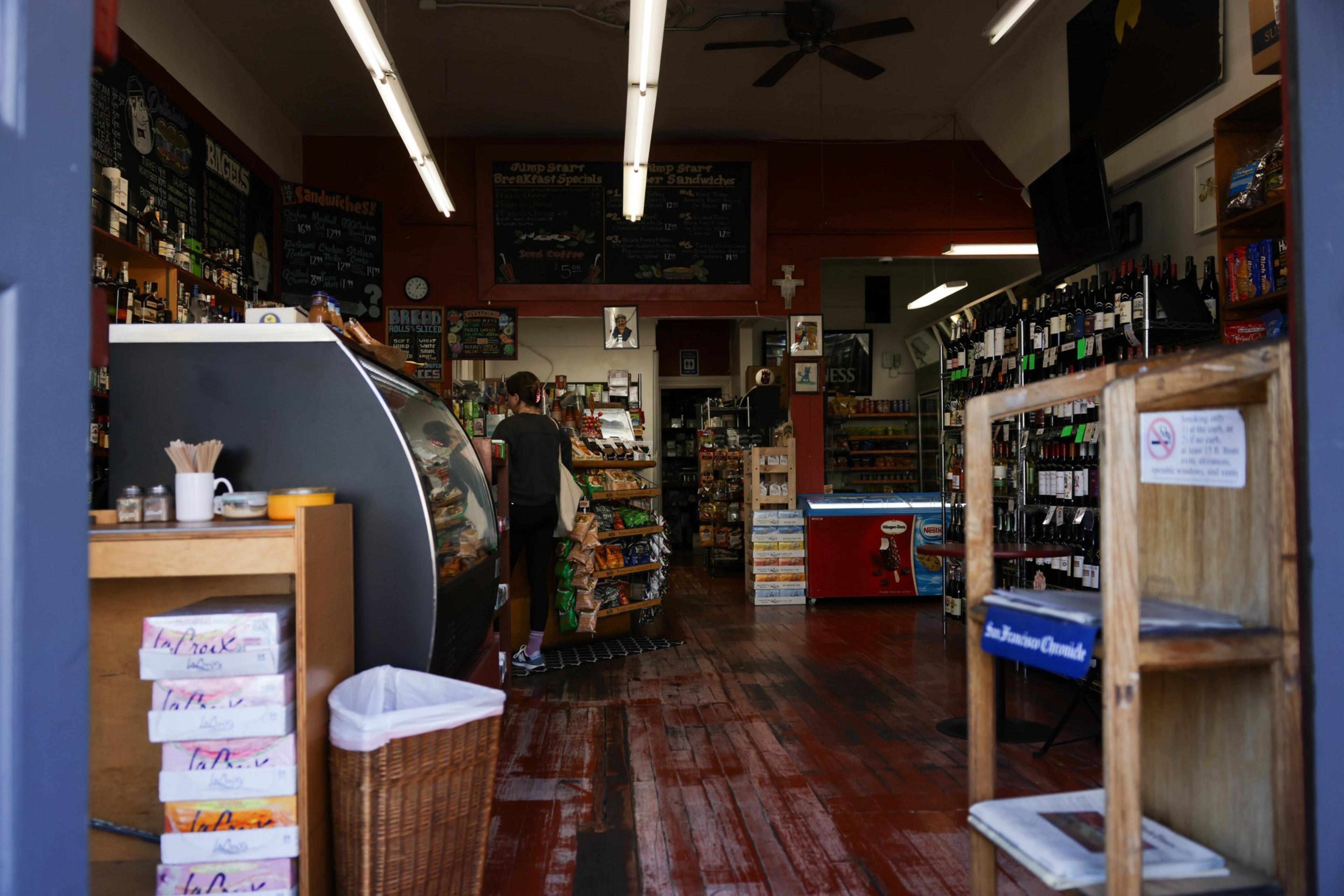 A customer shops inside of a corner store.