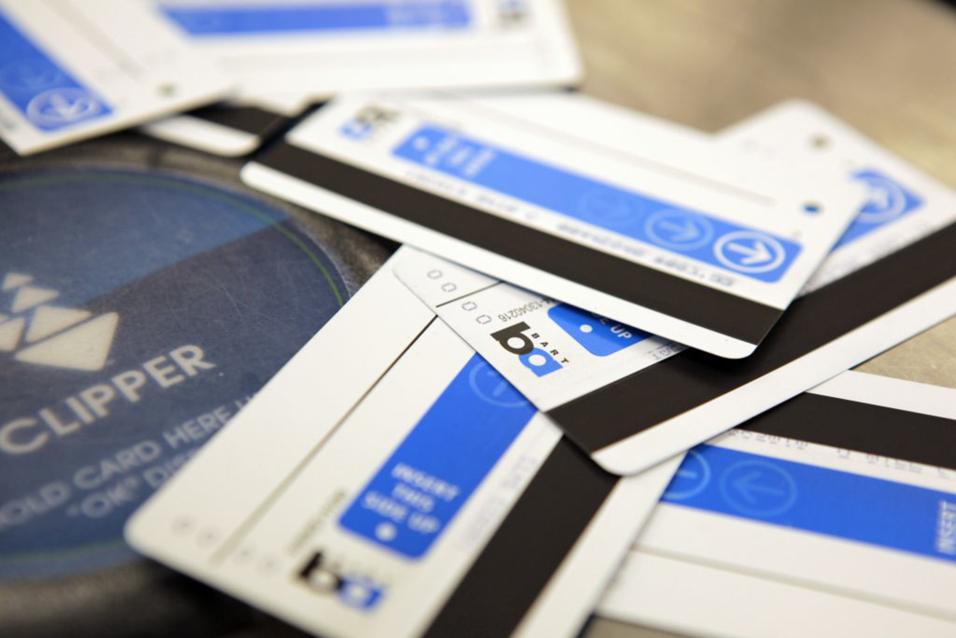 a close up shot of expired BART paper tickets and a Clipper card reader