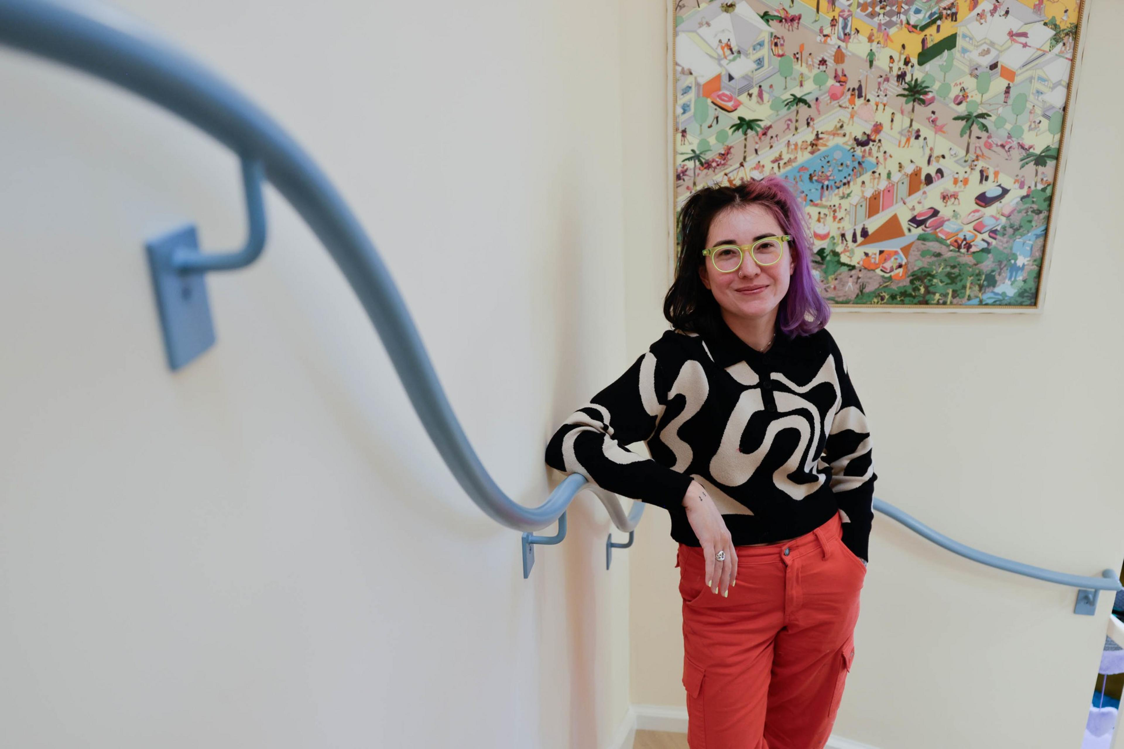 TikTok influencer Tay &quot;BeepBoop&quot; Nakamoto leans against a squiggly hand railing in San Francisco's Instagram hit, the Floral House. 