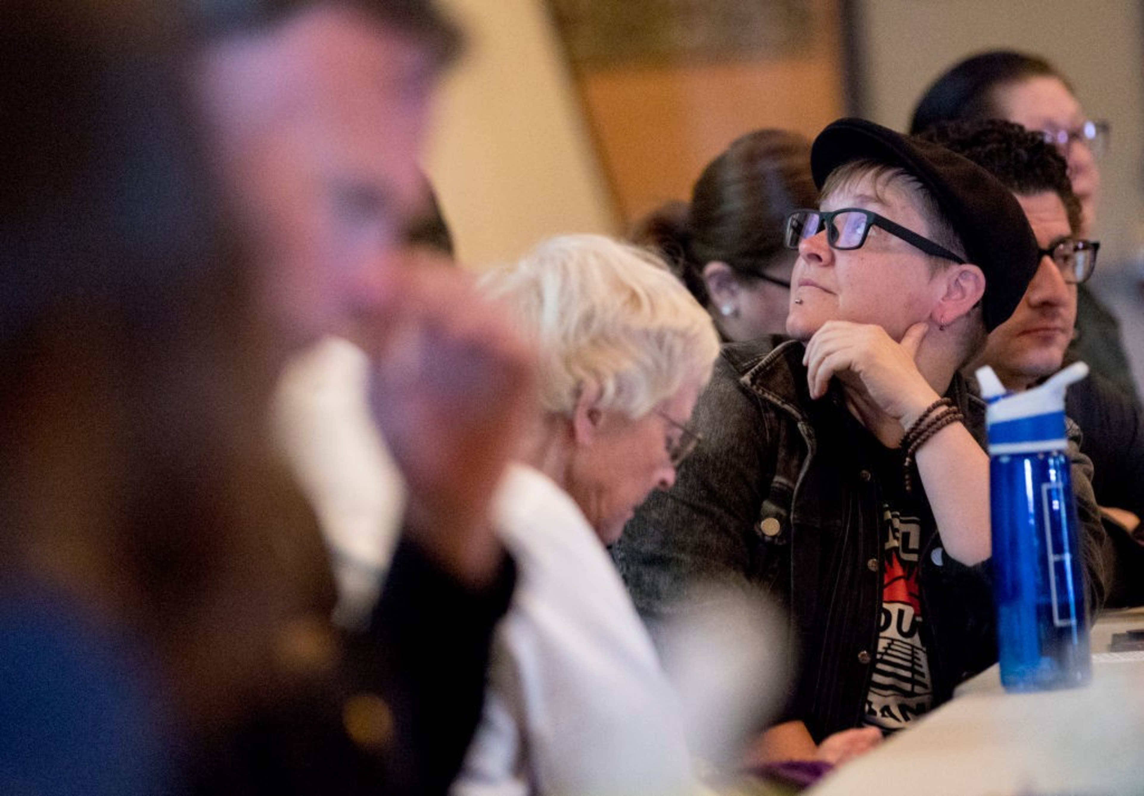 A person looks on at a public meeting.