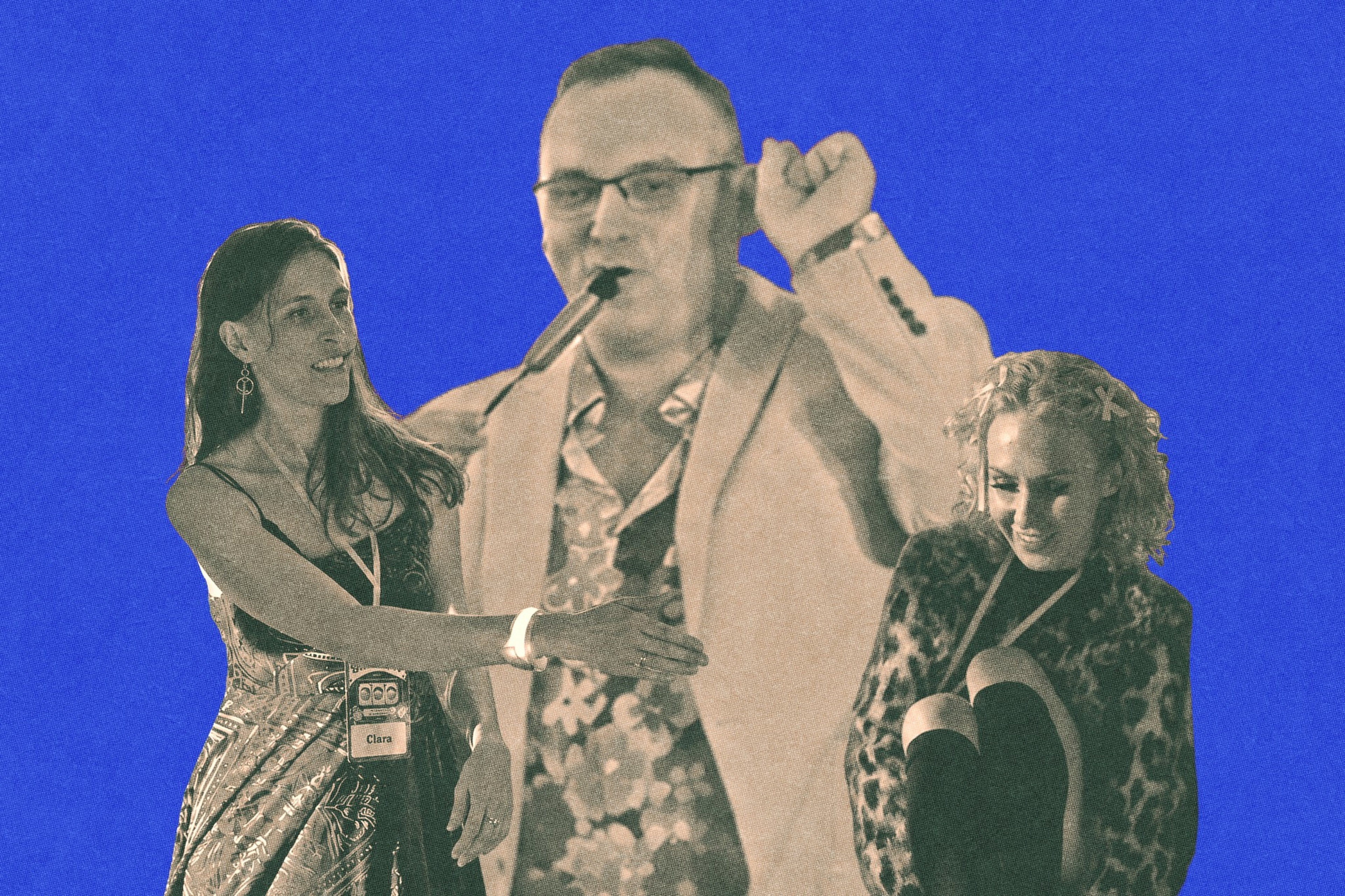 A woman wearing a name tag labeled "Clara" reaches out toward a man playing a flute, while another woman sits with her knees up, smiling.