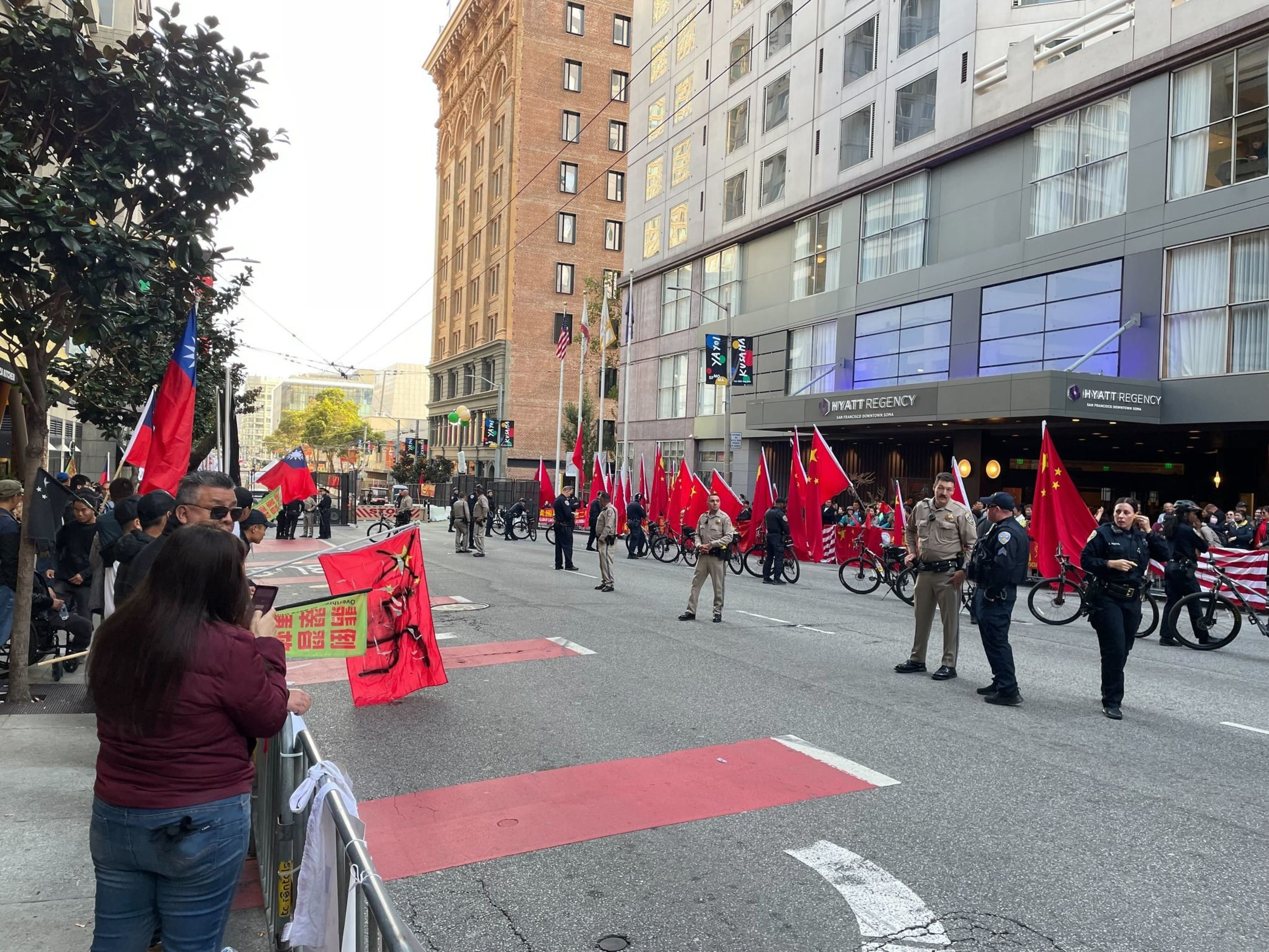 protesters line a street outside a hotel