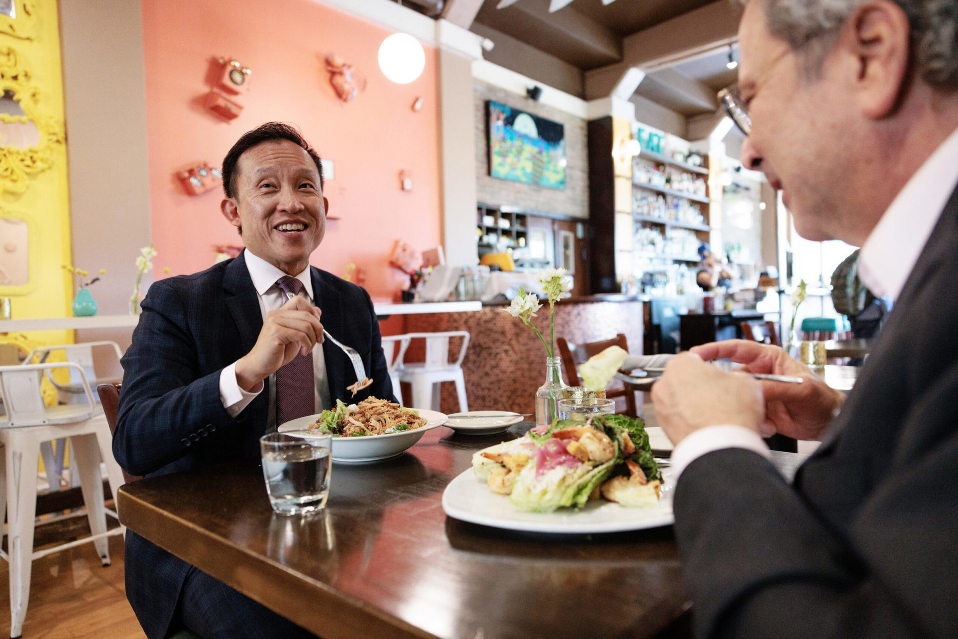 Two men eat.