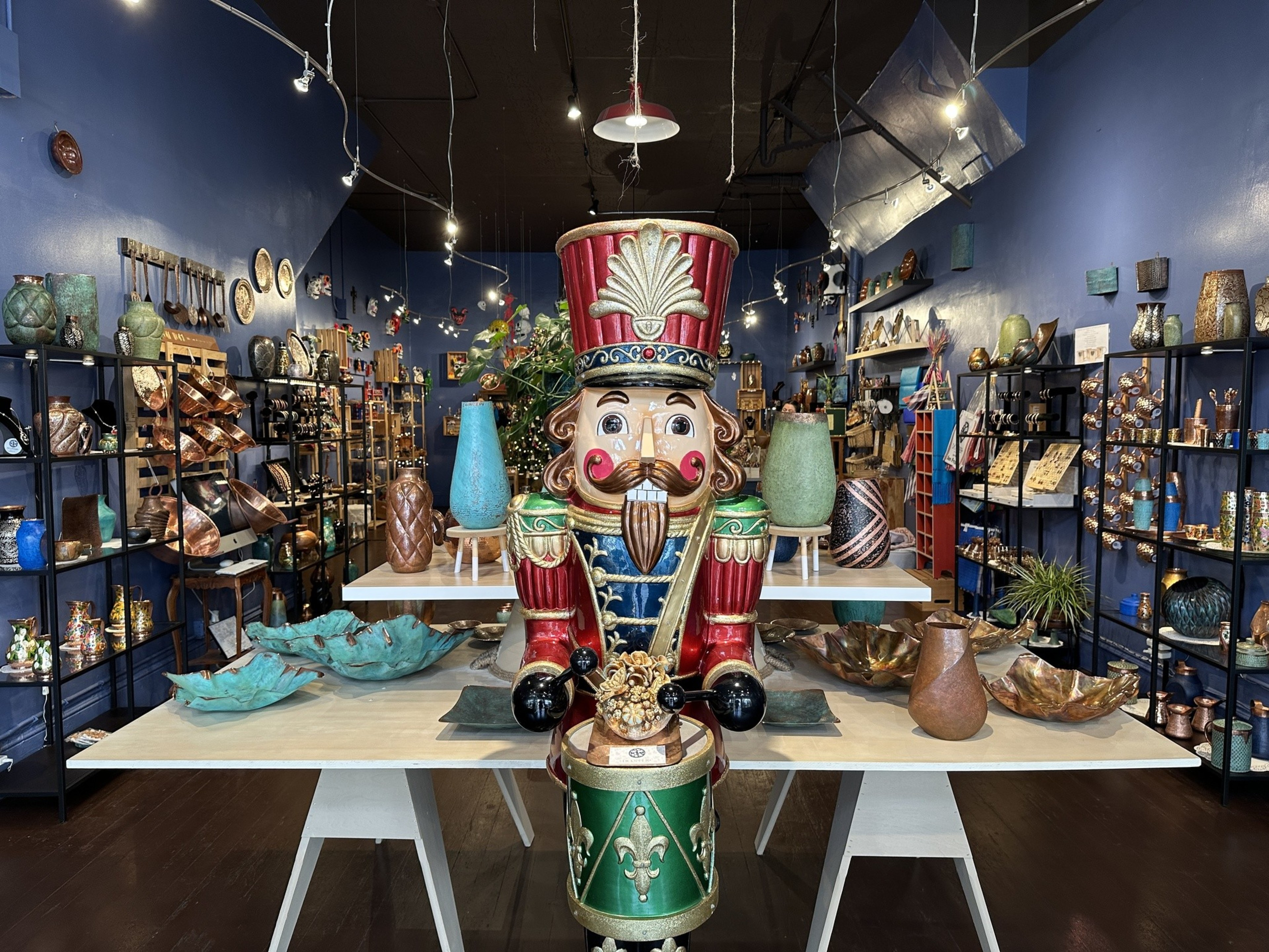 A giant Nutcracker statue stands at the entrance of a shop, which sells artisan-crafted copper vases, bowls and plates from Mexico.