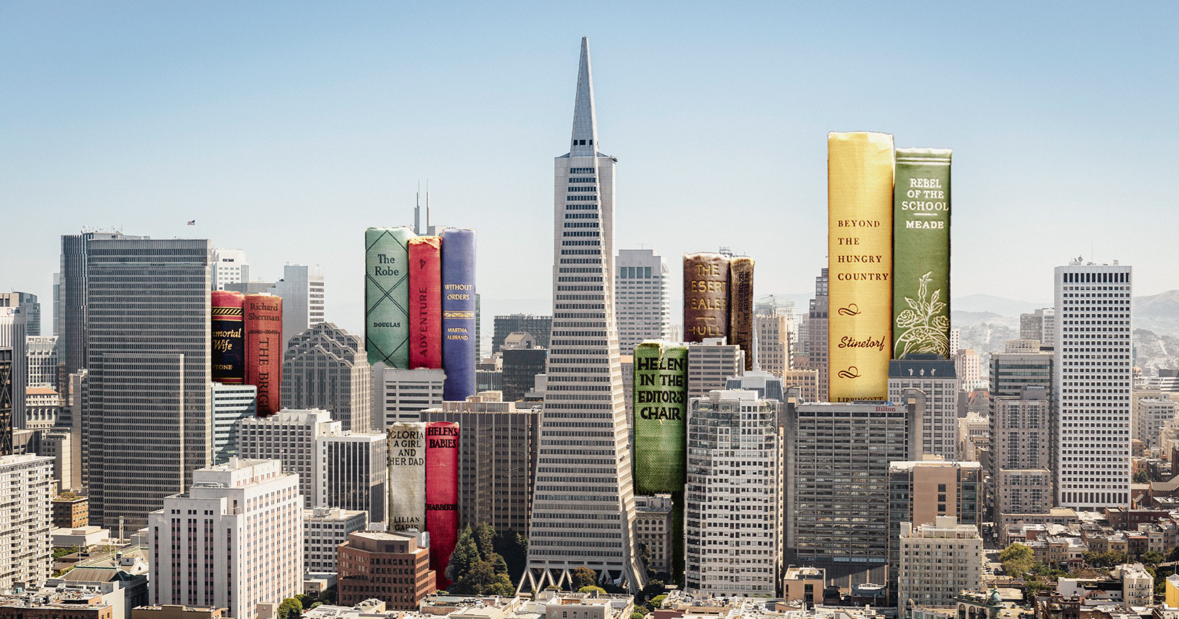A city skyline features several skyscrapers replaced with giant vertical books of various colors and titles among regular buildings.