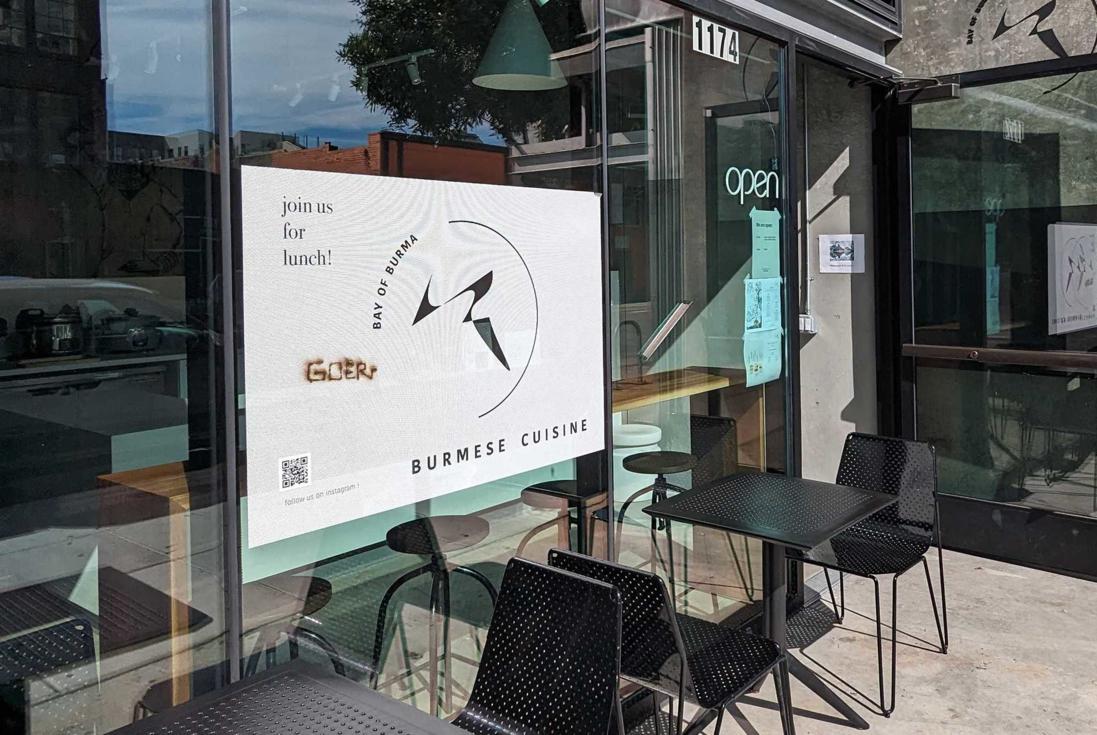 a shop window is seen with a brand burned into its signage