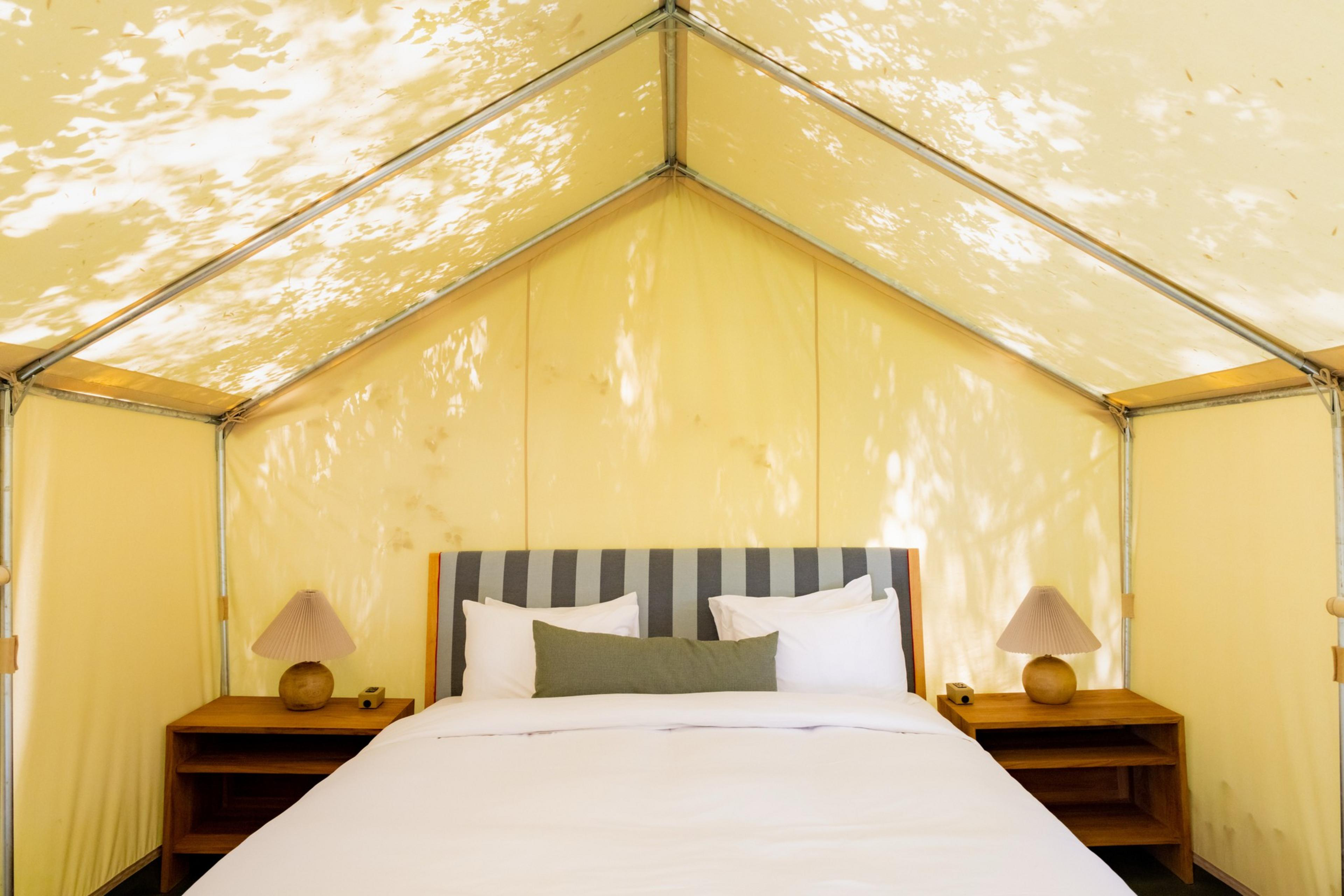 A glamping tent with a bed