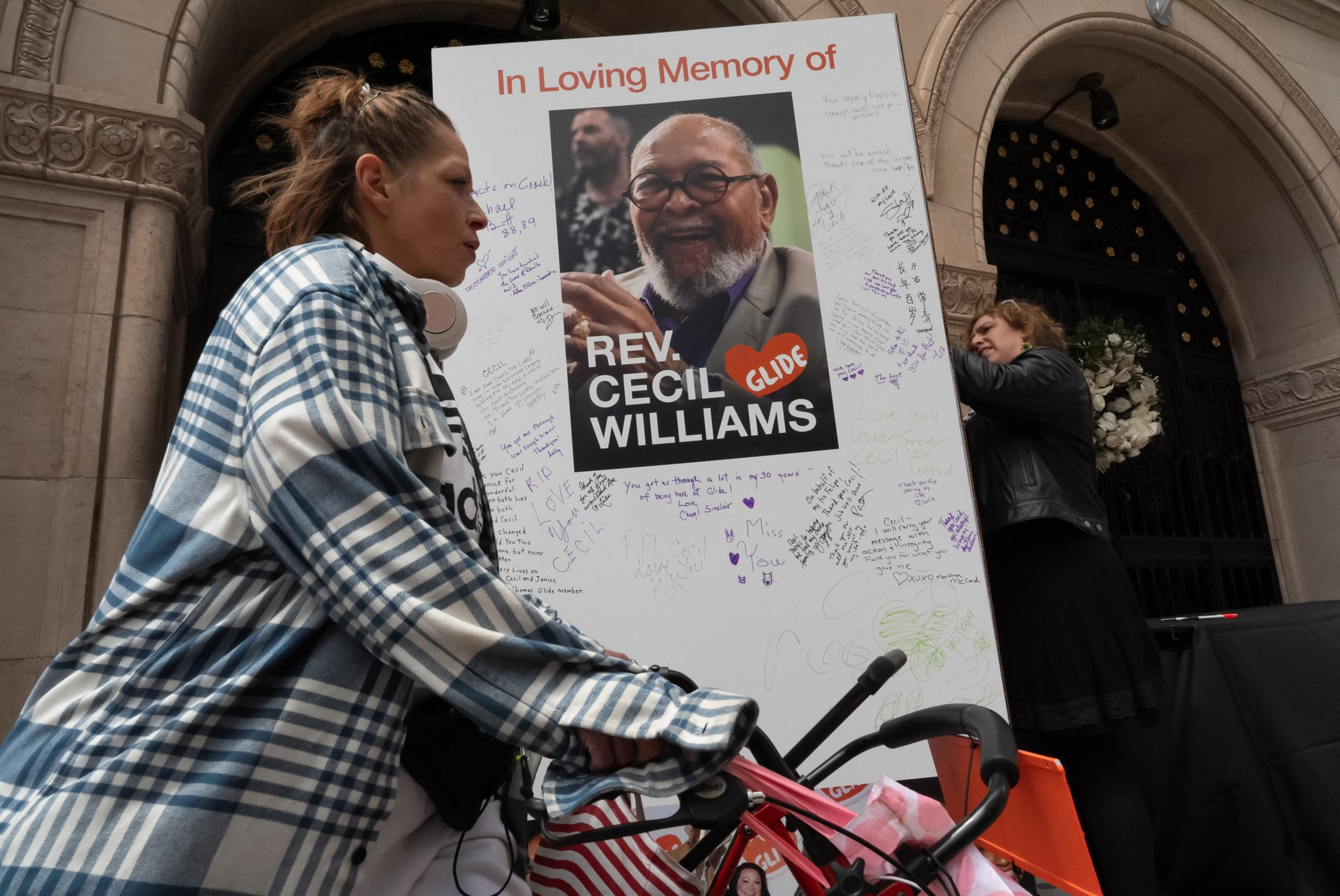 A woman signs a large memory card during a Celebration of the Life for co-founder Reverend Cecil Williams at the Glide Memorial Church Sanctuary in San Francisco on Sunday, May 12, 2024.
