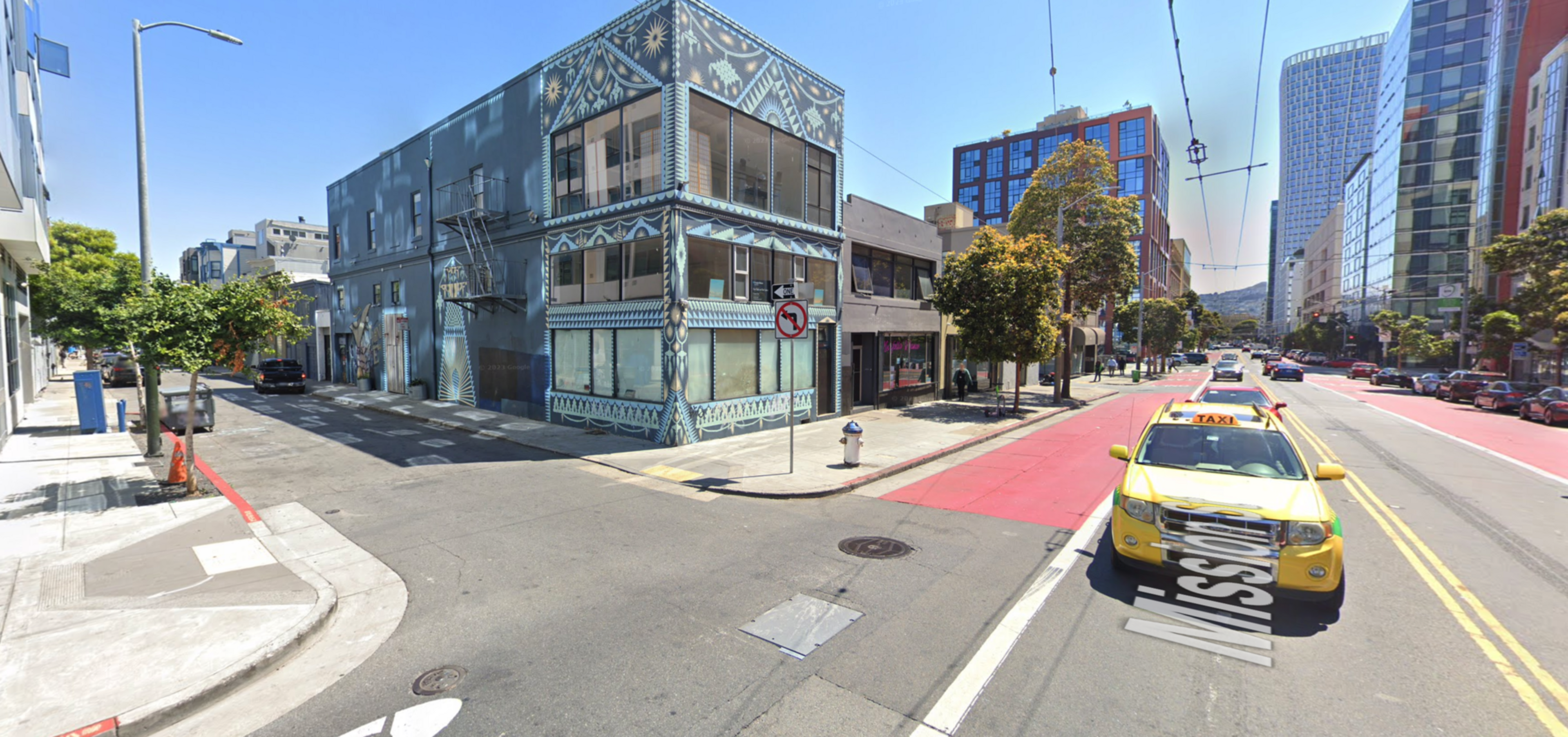 A car drives near the intersection of two streets.