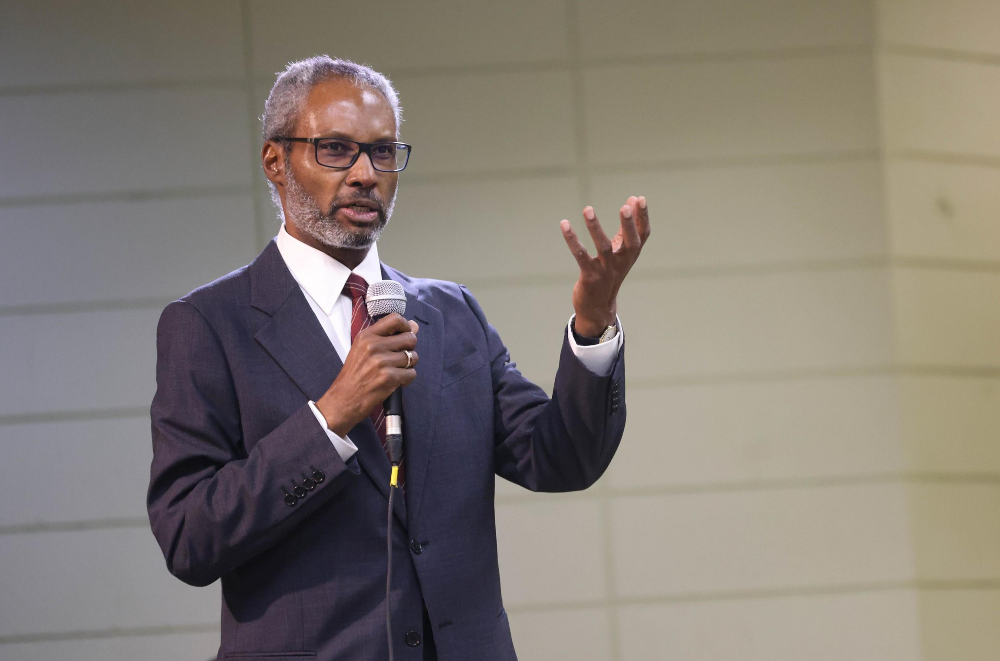 A man stands on a stage before an audience.