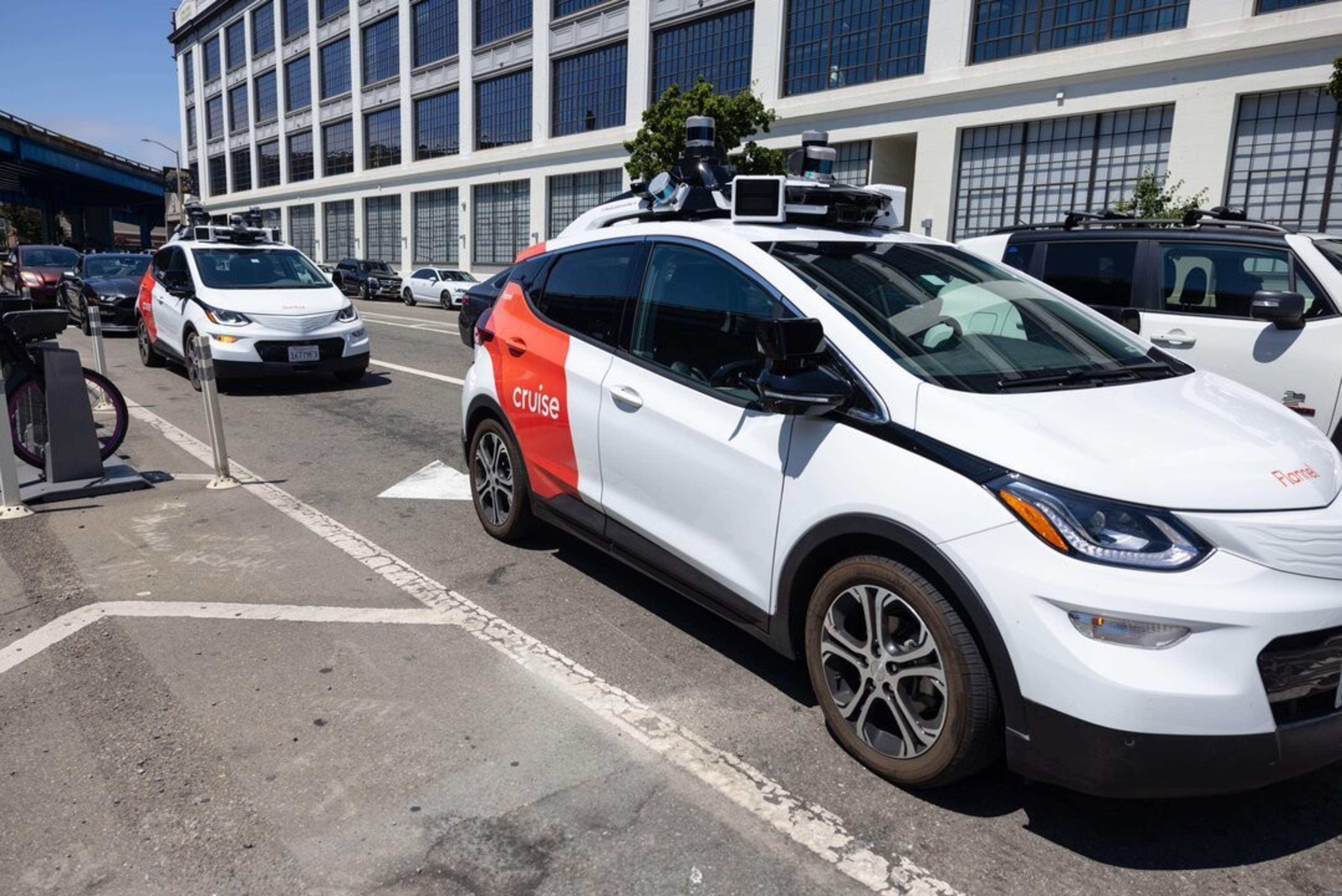 A Cruise vehicle, which is a driverless, autonomous robotaxi, at a stoplight during the day in San Francisco.