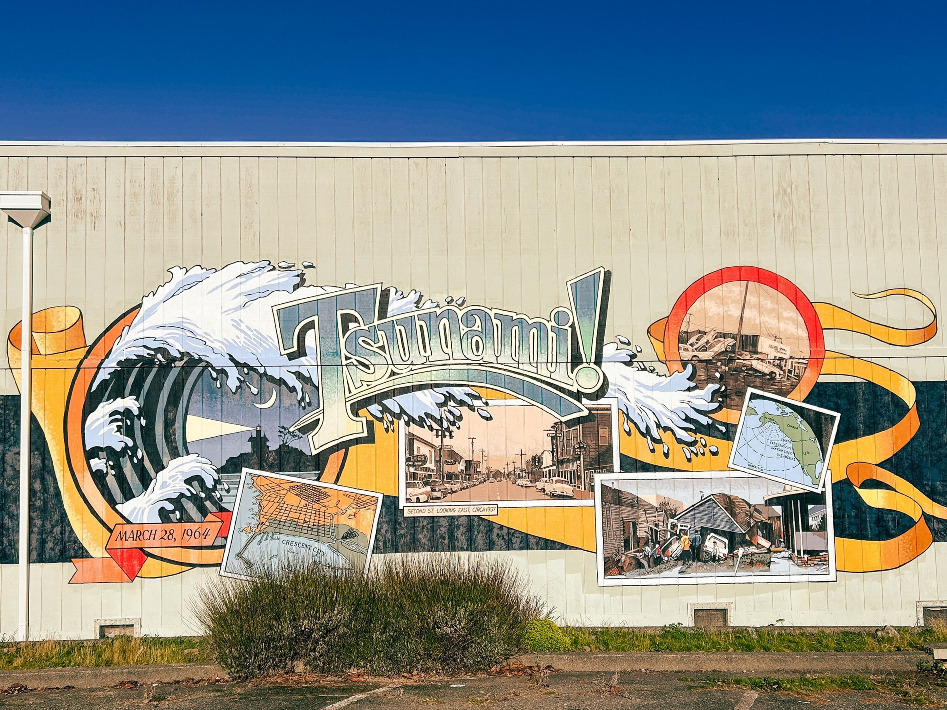 A mural features a large wave labeled &quot;Tsunami!&quot; with images of destruction, maps, and a date, March 28, 1964, depicted in a colorful, graphic style.