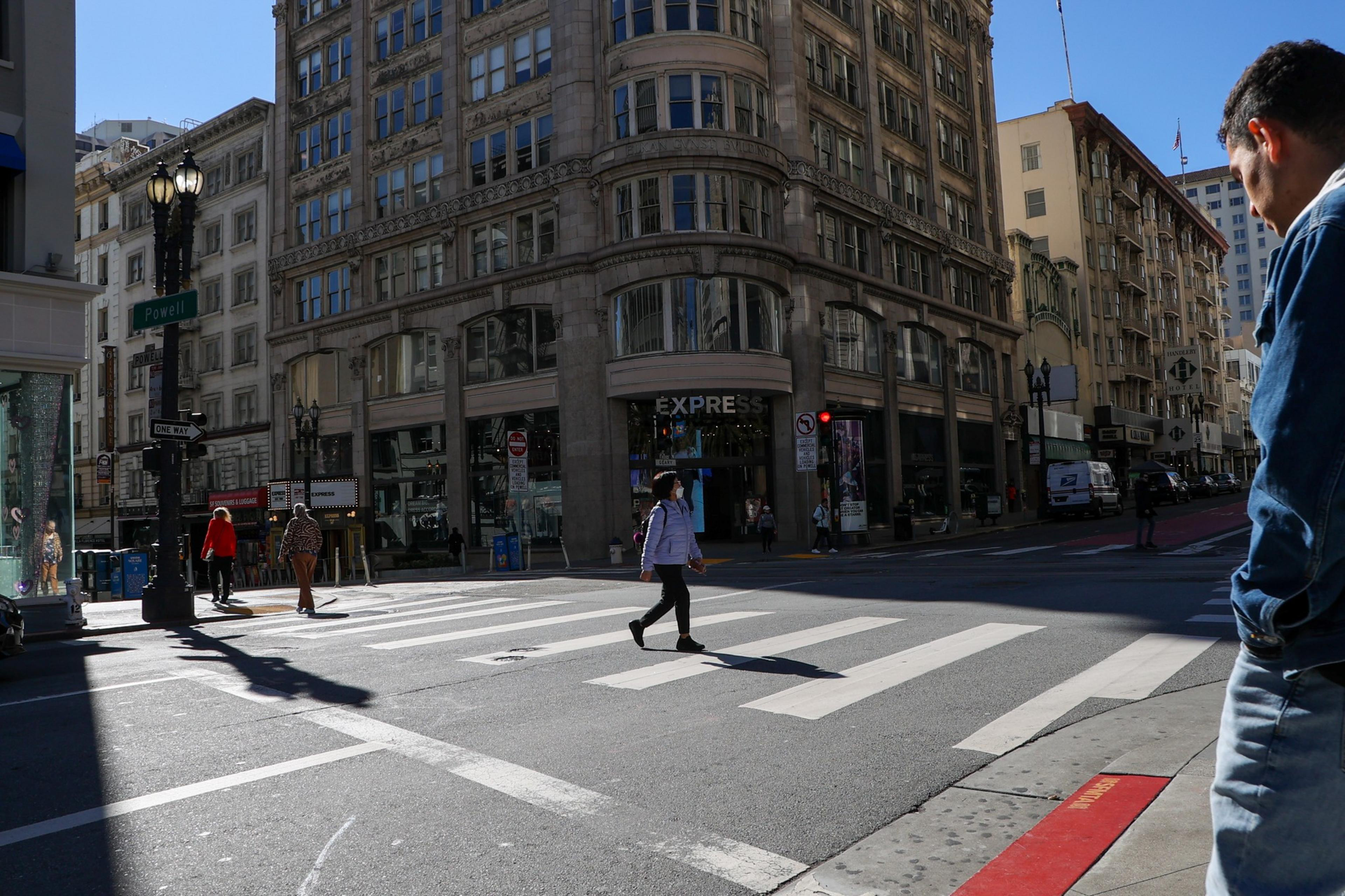 Tourists and San Francisco residents stroll the Financial District and Union Square on Feb. 1, 2022.