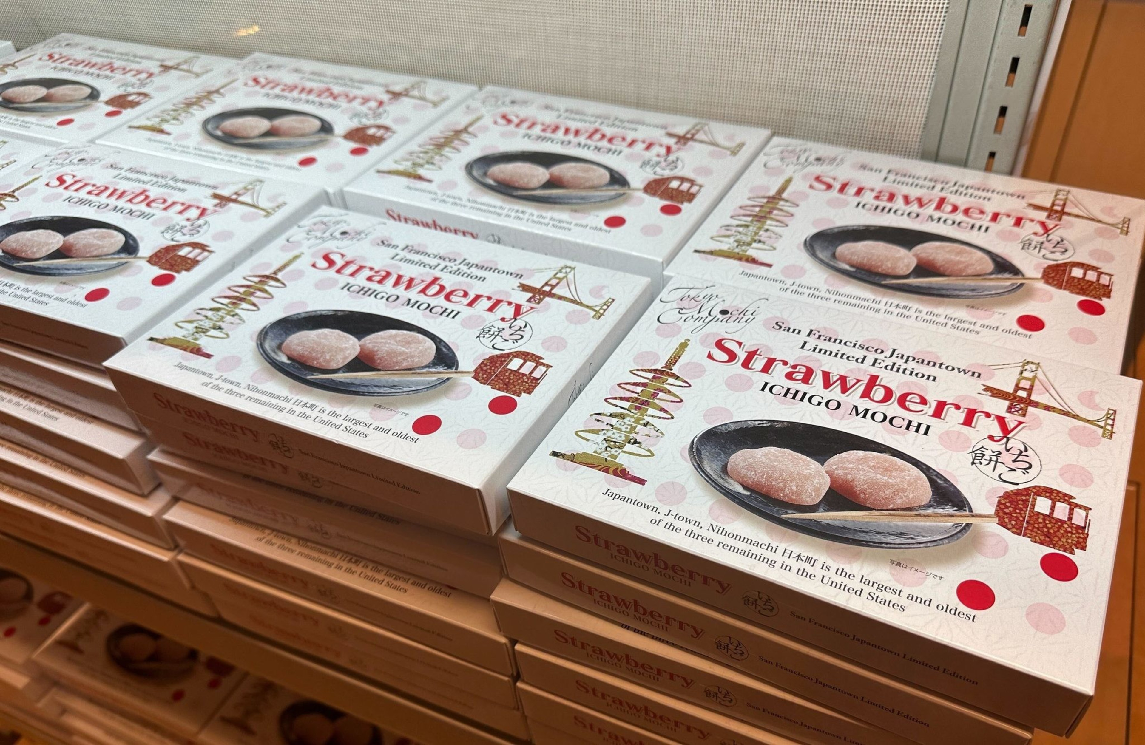 Boxes of strawberry mochi lay stacked on a shelf in a Japantown sweets shop in San Francisco.