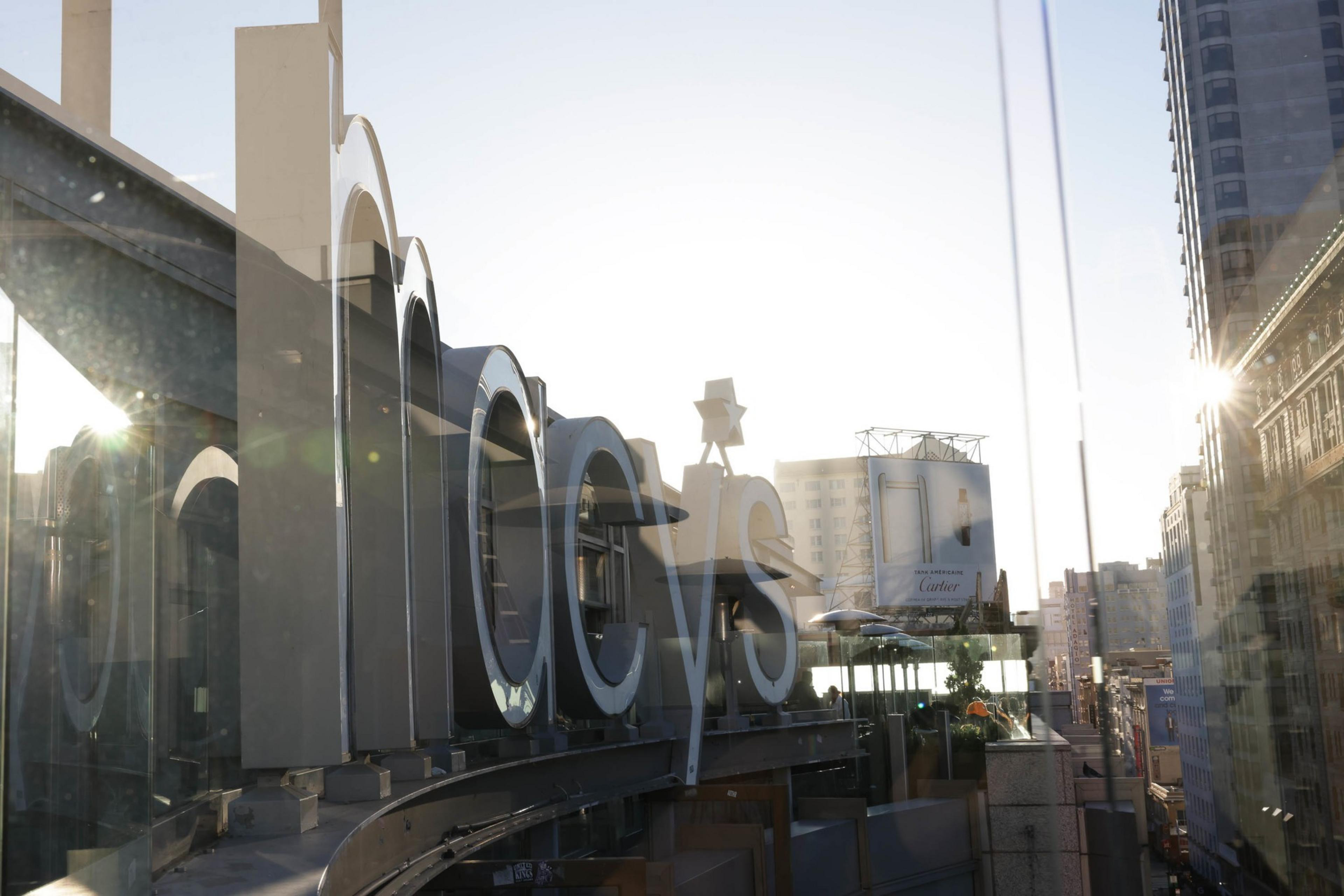 Reflection of downtown skyline in Macy's store windows