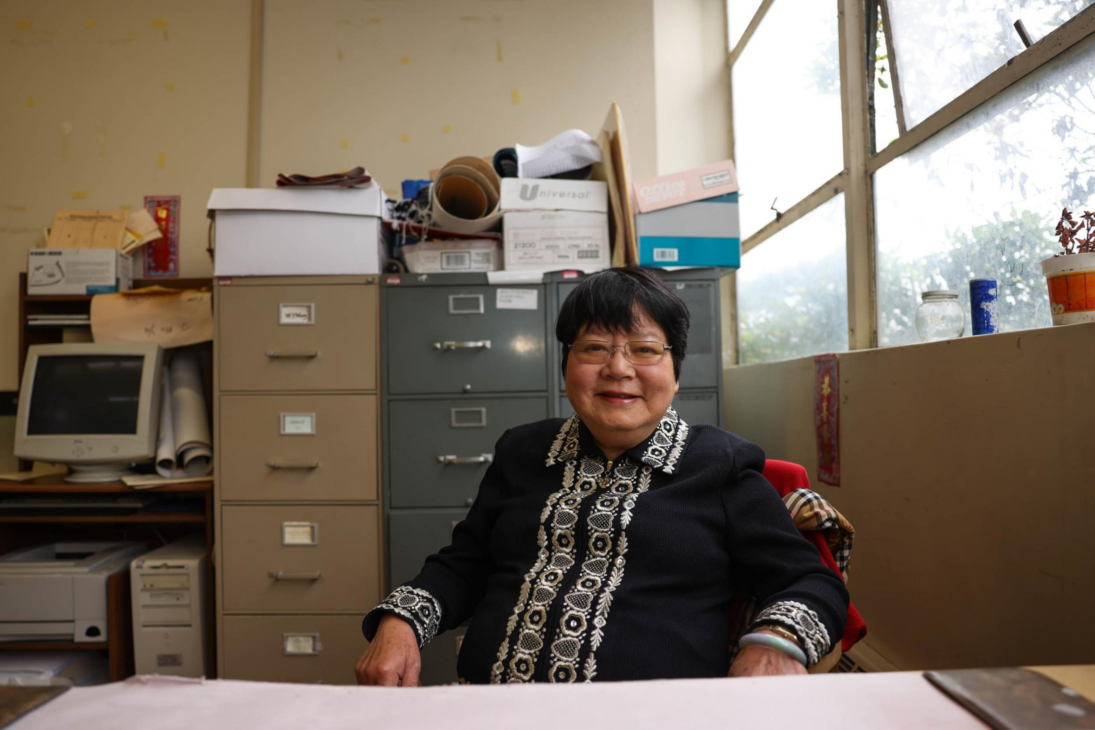 Professor Grace Yu poses for a portrait in her office at CCSF in San Francisco