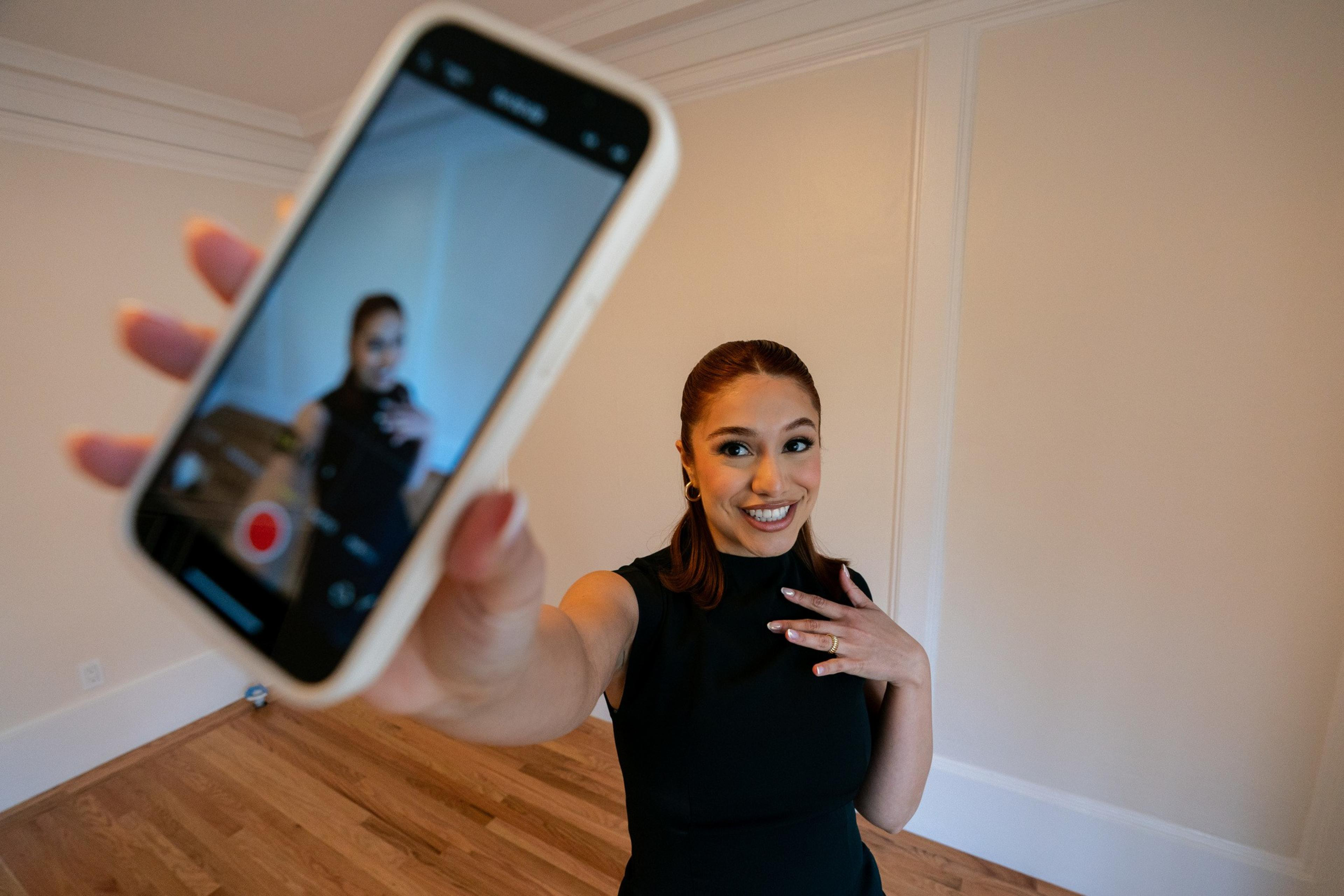woman films herself with her iphone